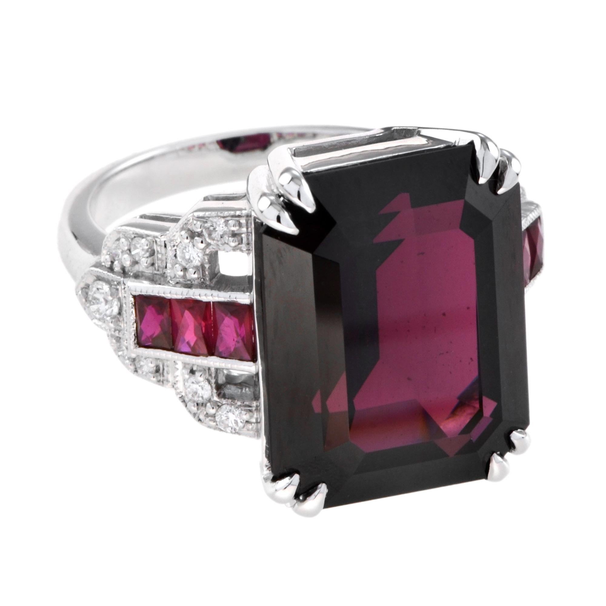 The ring features an elegant form, a perfect balance of stone and metal. The long shape of the setting is classic, allowing the ring to be set with the finest of emerald cut juicy scarlet rhodolite. Bright diamonds and French cut rubies transition