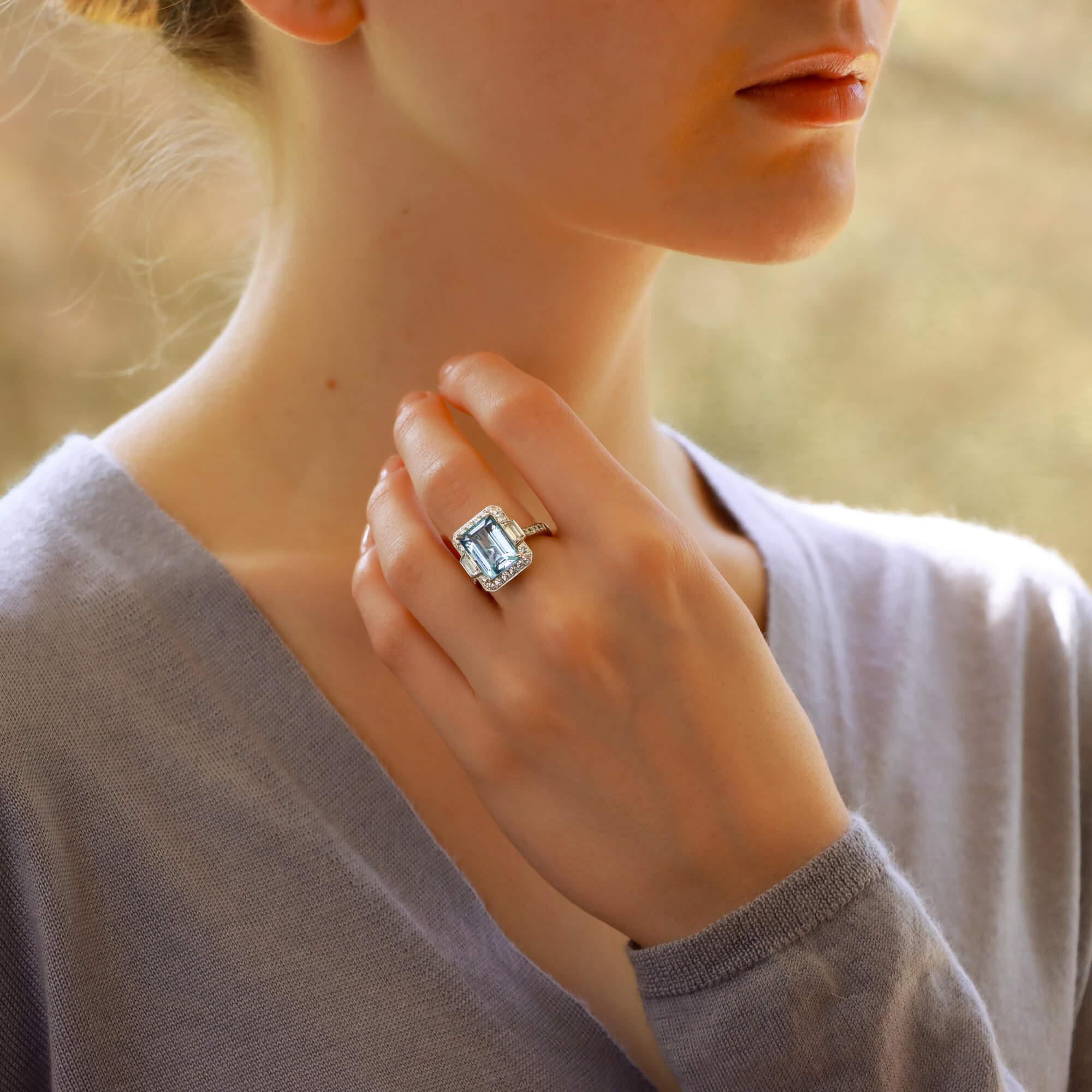 A truly stunning octagonal cut aquamarine cluster halo ring set in a platinum mount.

The piece is centrally four-claw set with a 6.02 carat octagonal aquamarine; which has a beautiful vibrant blue colour. The aquamarine had been cleverly sided by