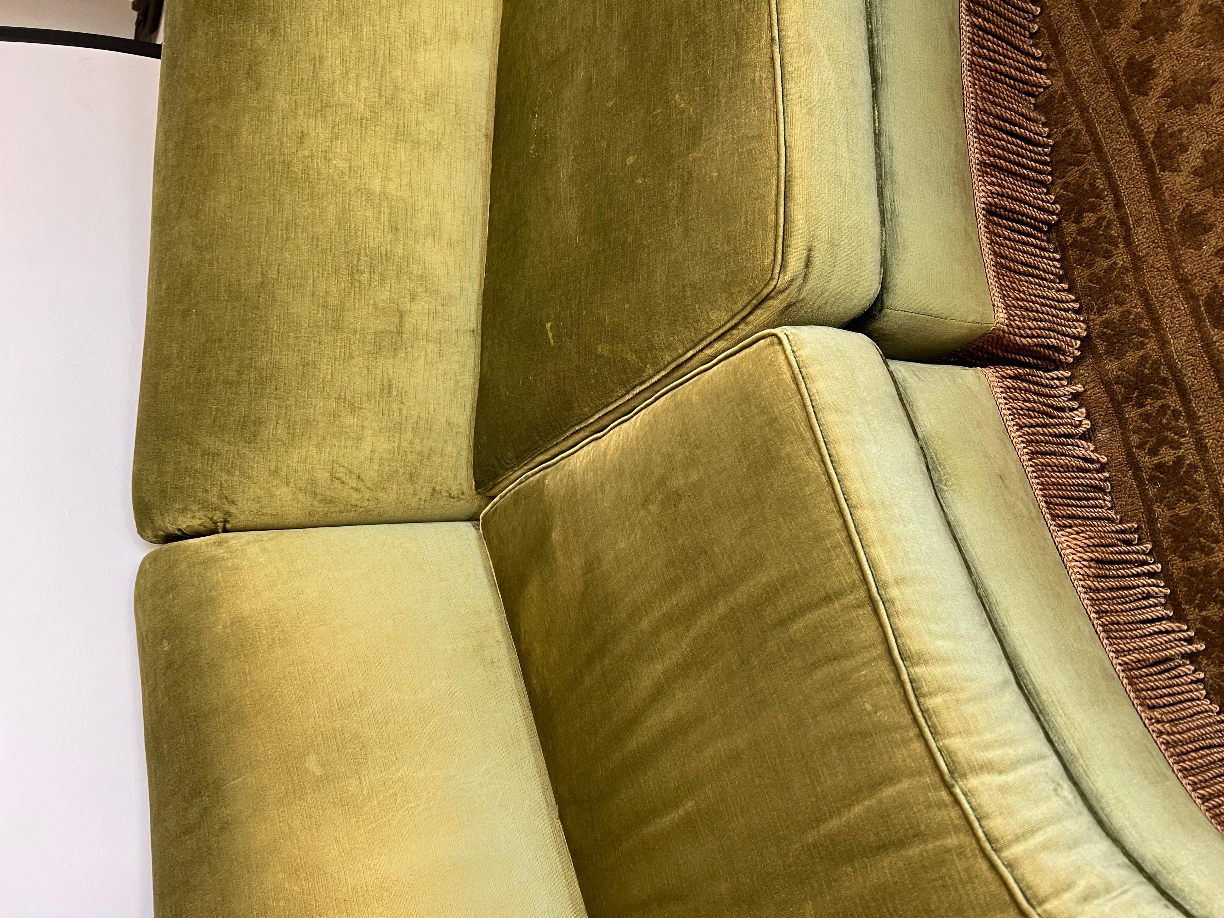 Exquisite art deco style 2 pc curved sofa has luxurious olive green velvet with gold tassel fringe. It is button tufted inside arms.
Front to back depth is 47