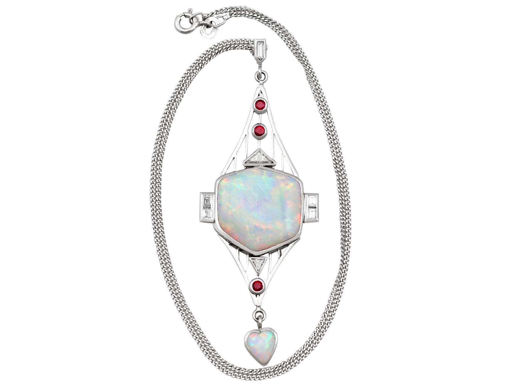 A stunning, fine and impressive opal, 0.85 carat diamond and 0.15 carat natural ruby, Art Deco style platinum pendant; part of our diverse gemstone estate jewelry collections.

This fine large opal pendant has been crafted in platinum.

The pendant