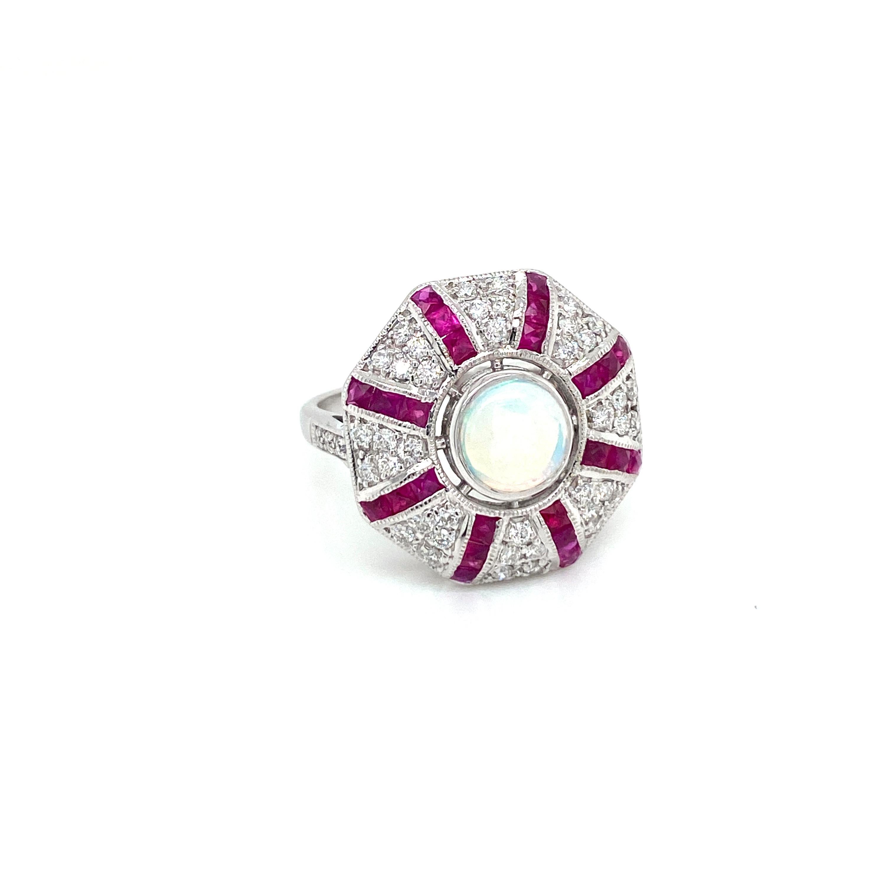 Beautiful Gold handmade Art Deco style ring.
It is set in 14k white Gold featuring a large sparkling vivid Opal in the center, weight 5,50 ct., surrounded by 1.00 ct custom cut natural Ruby and Round brilliant cut diamonds totaling 0.80 carats G/H