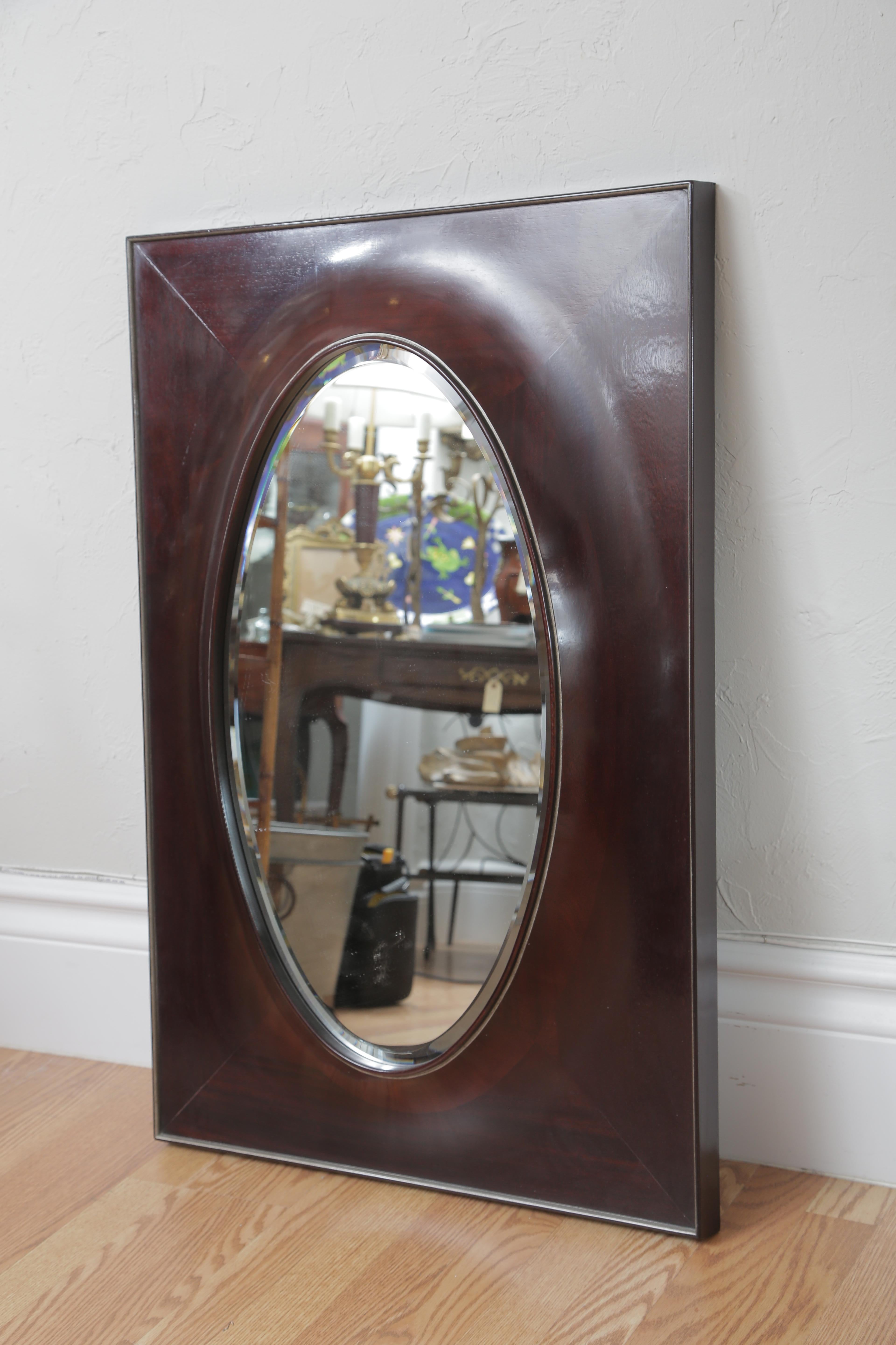 Dark Mahogany Oval wood mirror in the art deco style by Barbara Barry for Baker.