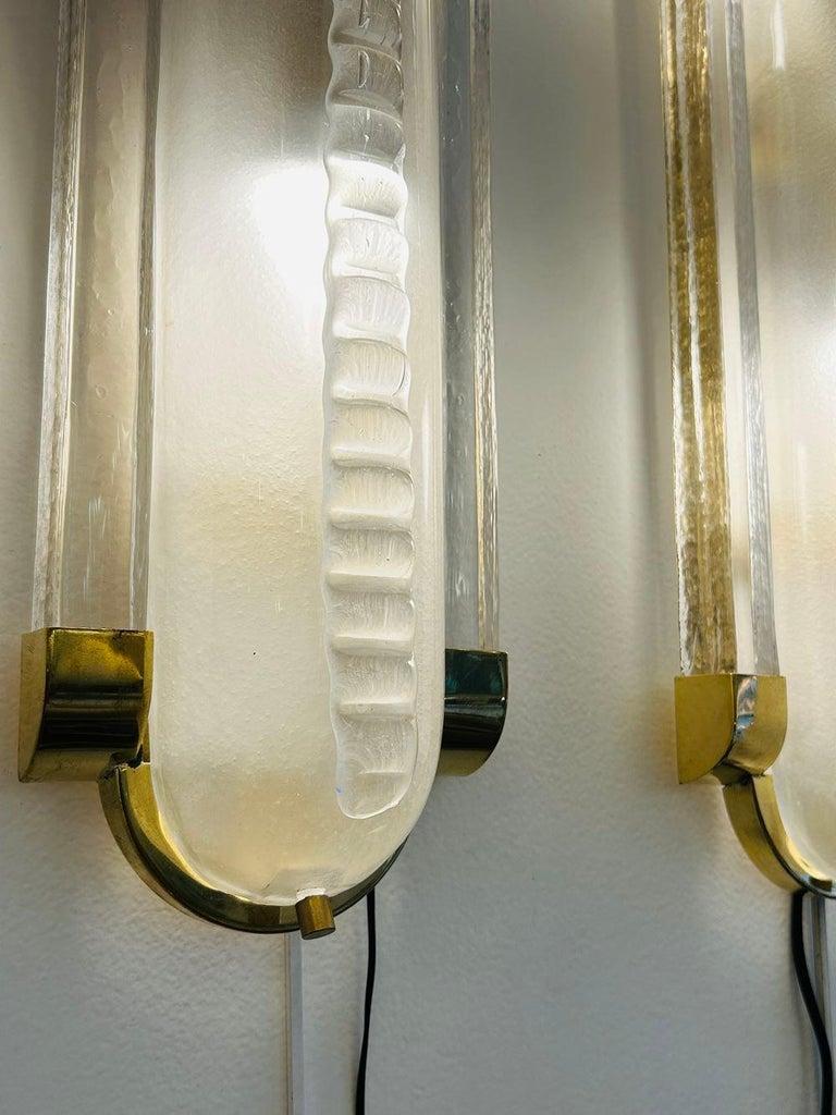 Beautiful pair of wall sconces in Murano curved satiny glass. Notches decor.
