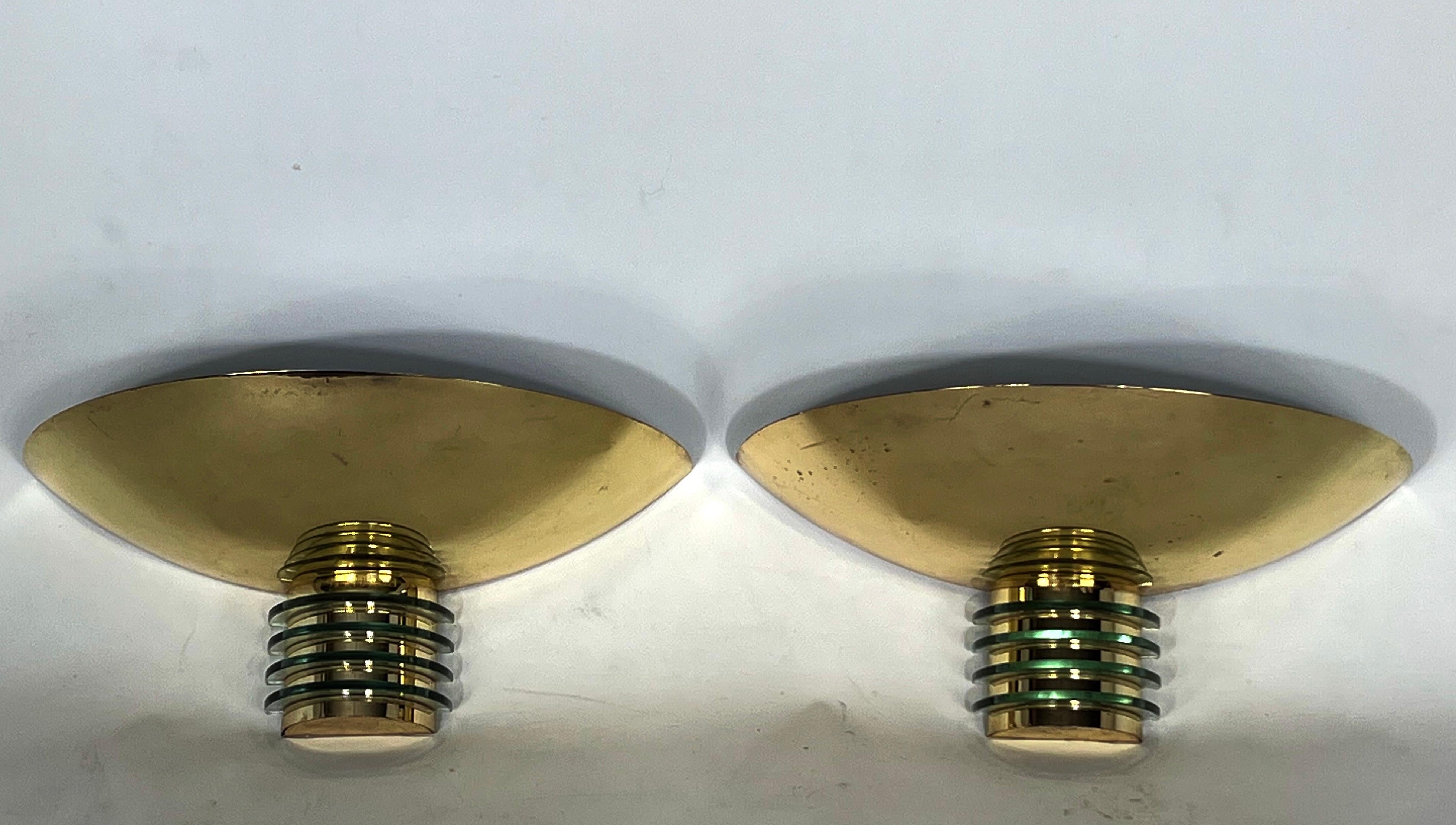 Good vintage and original condition with normal trace of age and use for this set of two sconces produced in France by SCE in Art Deco style. 1970s. They're made from gilded metal in original patina with small dots and glass.