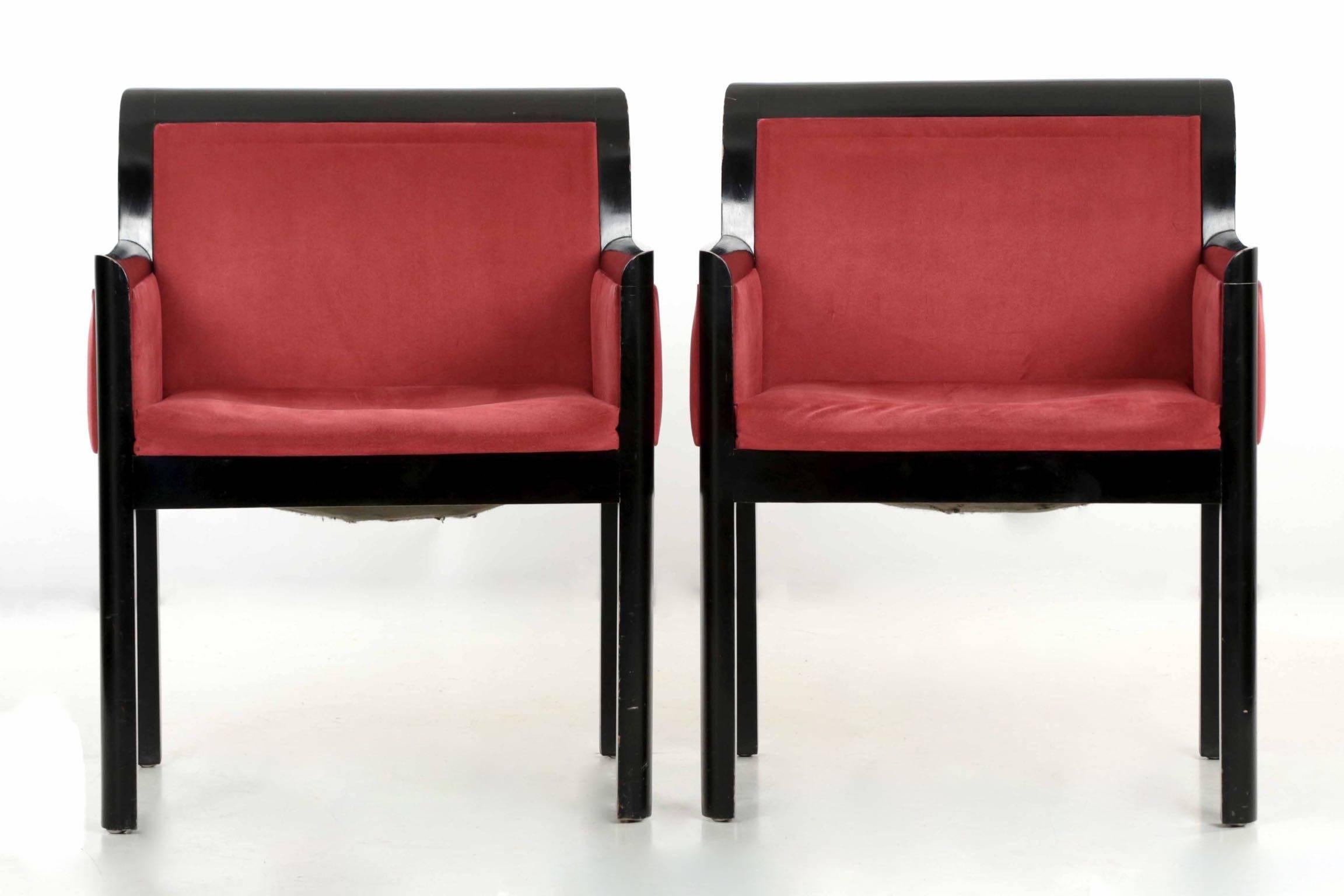 These very attractive contemporary armchairs are beautifully ebonized over what appears to be a maple hardwood, the edges curving outward to create sharp horizontal lines throughout the squared frame. They are upholstered in a maroon micro-suede