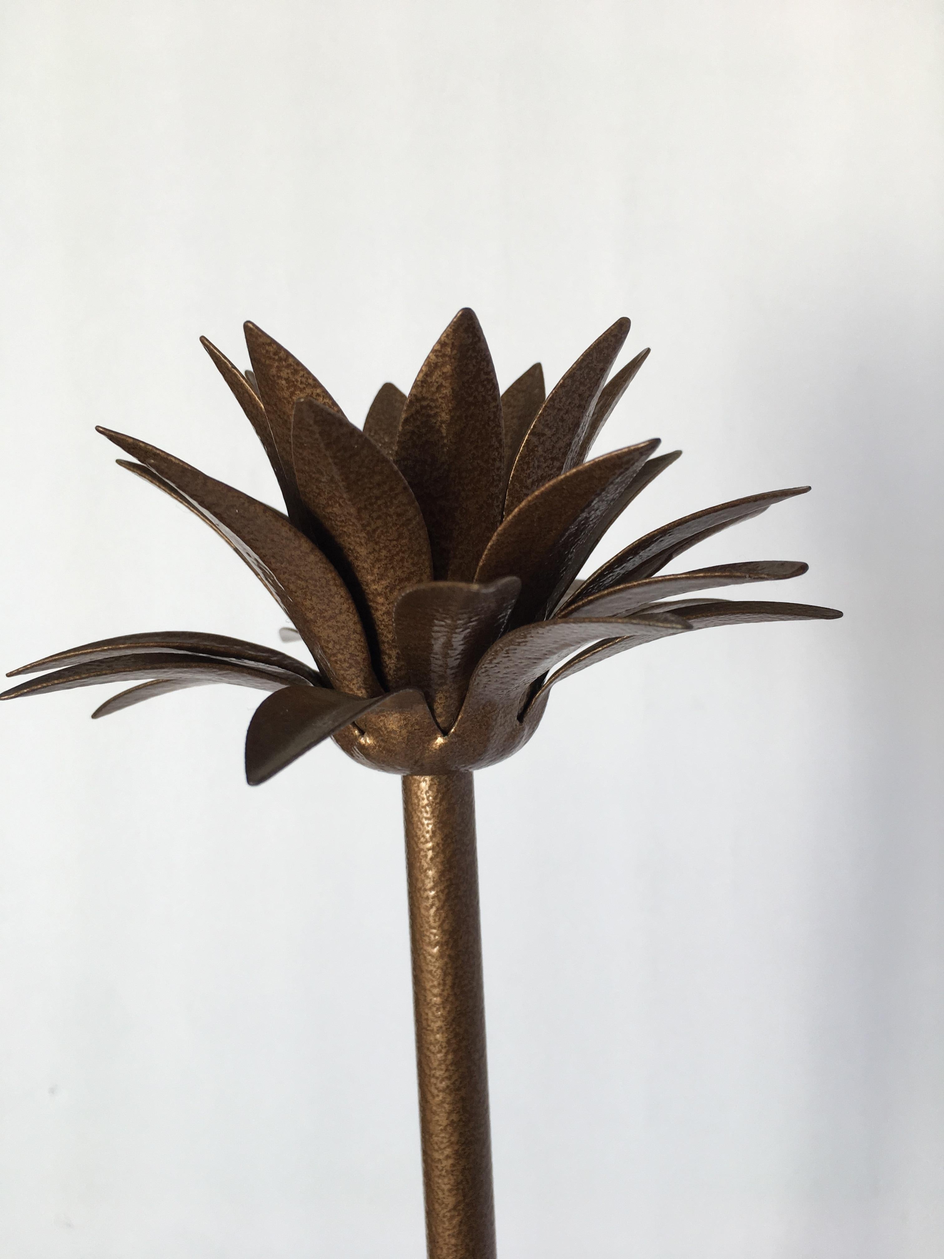 Art Deco style palm leaf candlestick holder with a faux bronze finish.