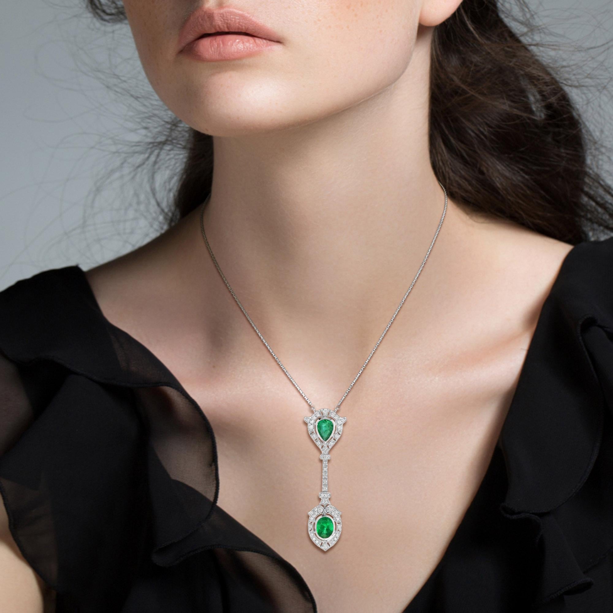 Exquisite elegance, this one-of-a-kind Art Deco inspired emerald and diamond necklace showcase 3.17 carats of vibrant pear and oval shaped emeralds surrounded by old cut diamonds set in 18k white gold with a matching chain necklace. Captivating and