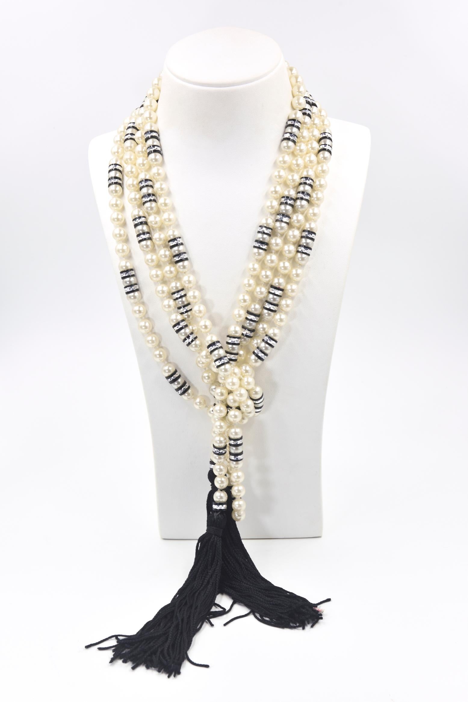 Art Deco-style cultured pearl necklace strung with black and silver resin rondels ending in black tassels. Without the black tassels the necklace is 94.62