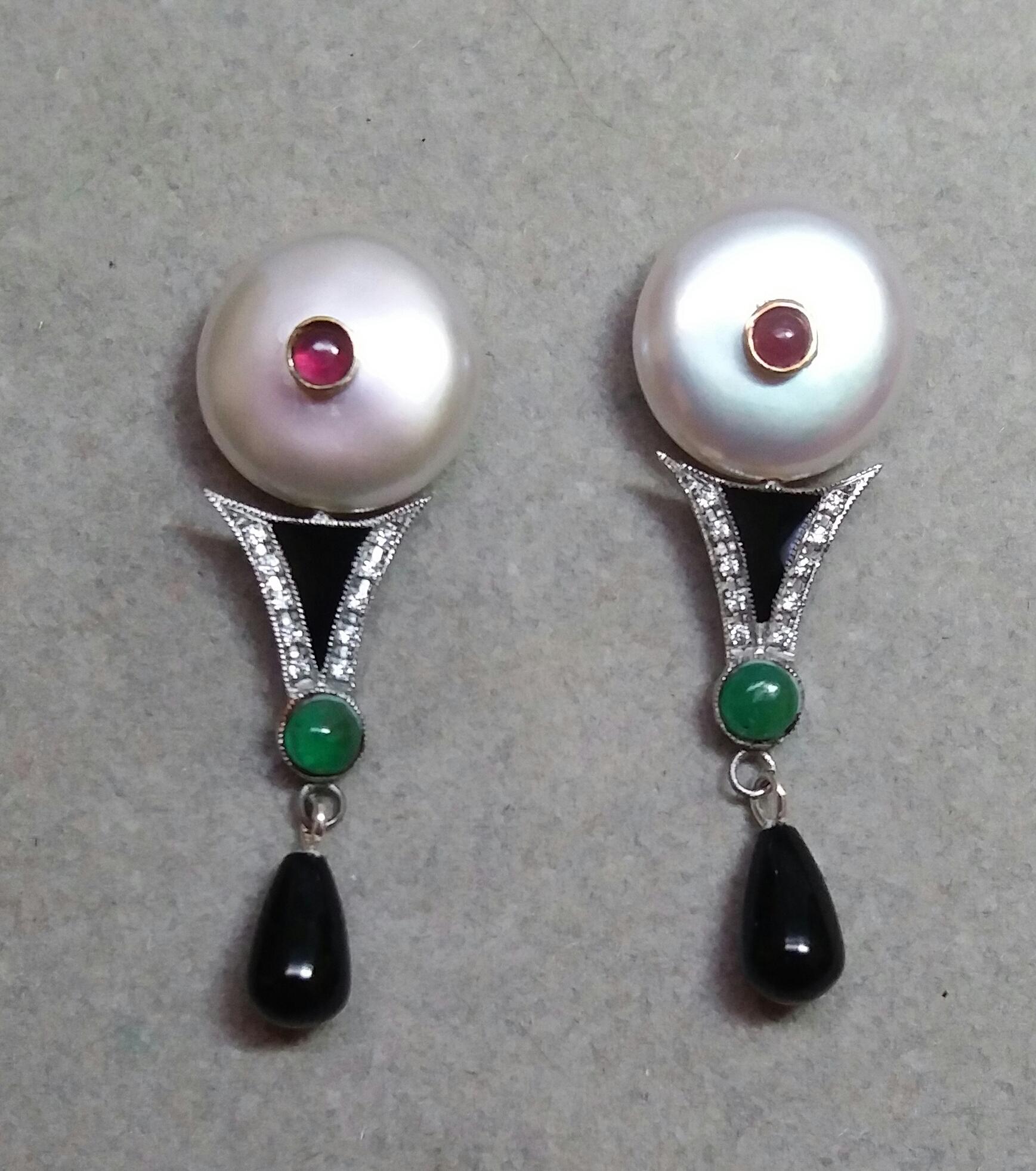 Art Deco Style earrings with 1 pair of 14 mm. flat round fresh water pearls and small round ruby cabochons in the center, middle parts in white gold, 20 full cut small round diamonds,2 small round emerald cabs and black enamels,bottom parts have 2