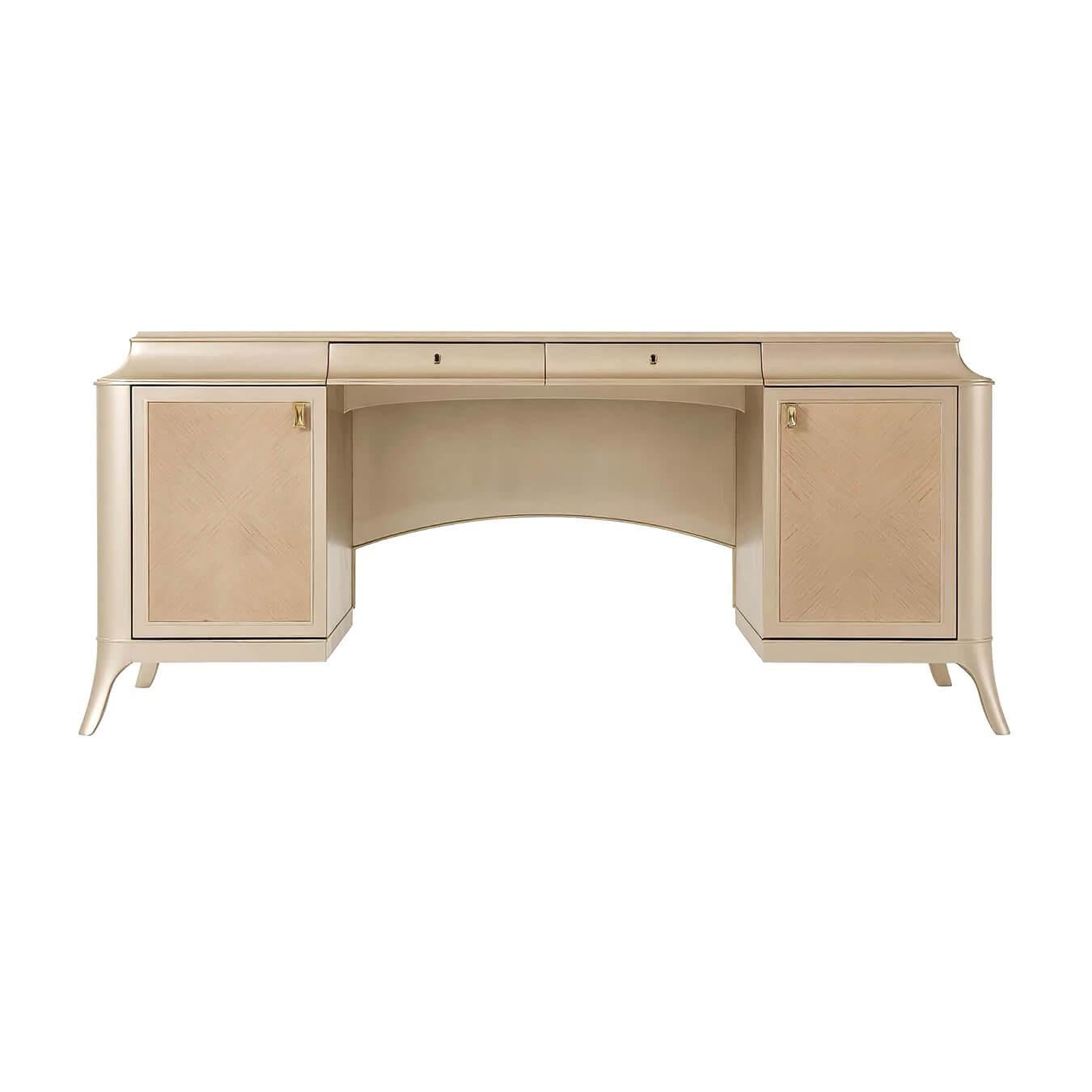 An Art Deco inspired desk with a molded platform top with an inset leather inlay finished in a sepia finish with simulated oak veneered doors and sides. Each door enclosing cabinets with adjustable shelves, the reverse side with a modesty panel,