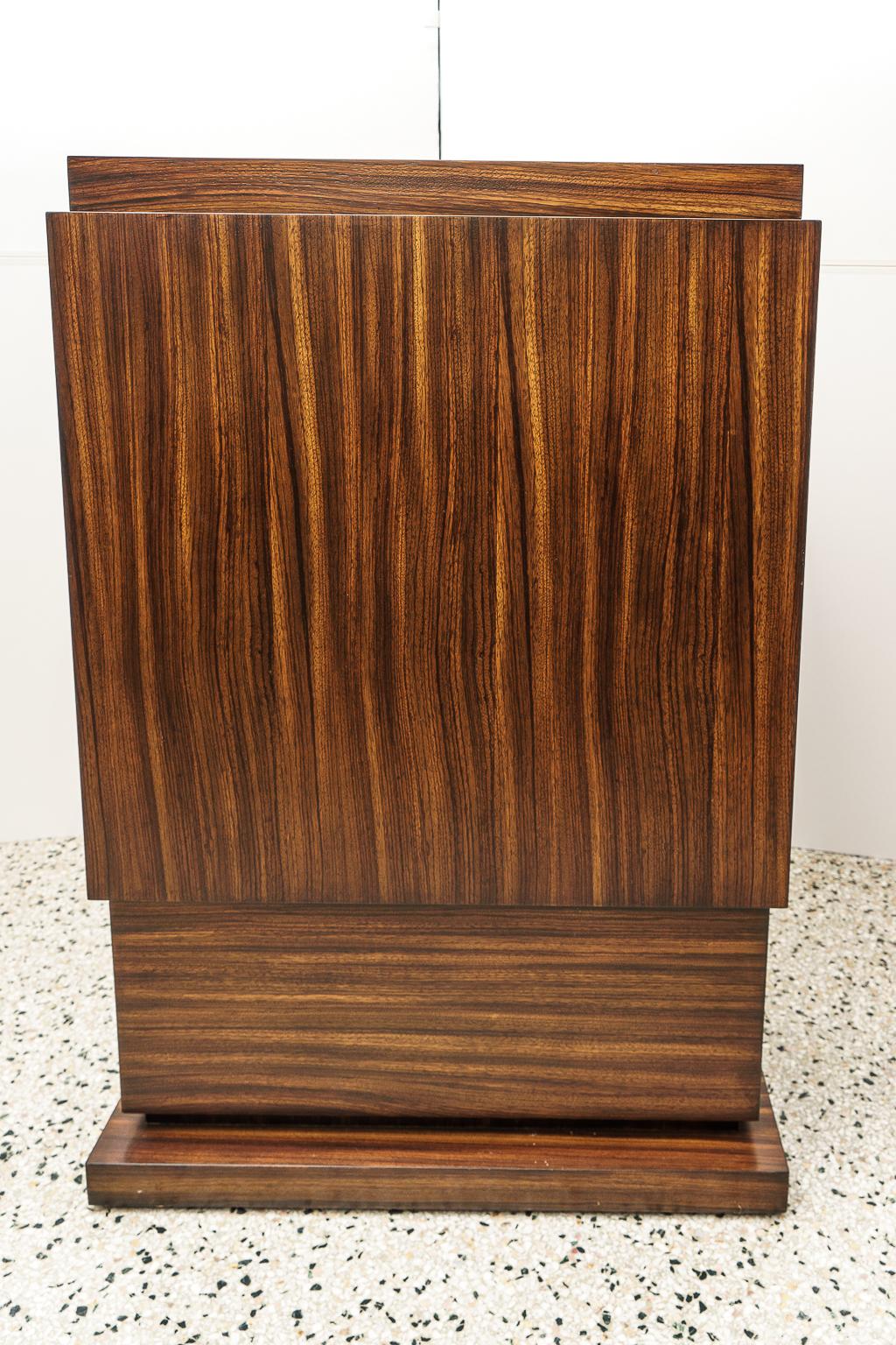 Art Deco style pedestal in Zebrano wood.
Acquired from a Palm Beach estate - 

Note the top surface measures 27 1/8 x 10 3/4 inches.
 