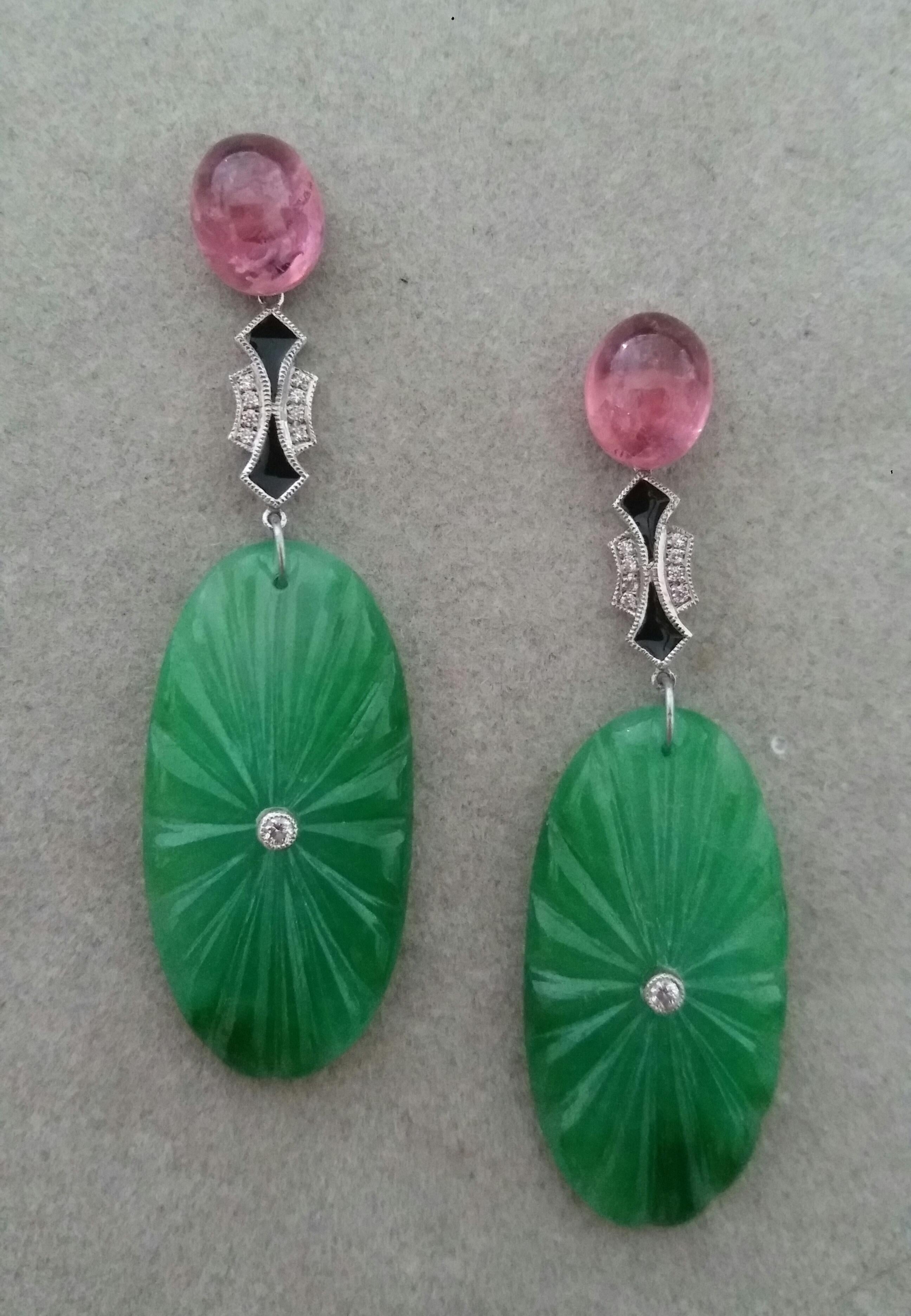  A pair of elegant  classic Art Deco style earrings, with the upper parts consisting of 2 Pink Tourmaline oval cabochons, in the central part  we have 2 elements in white gold, diamonds and black enamel,that support 2 engraved oval shape Jades