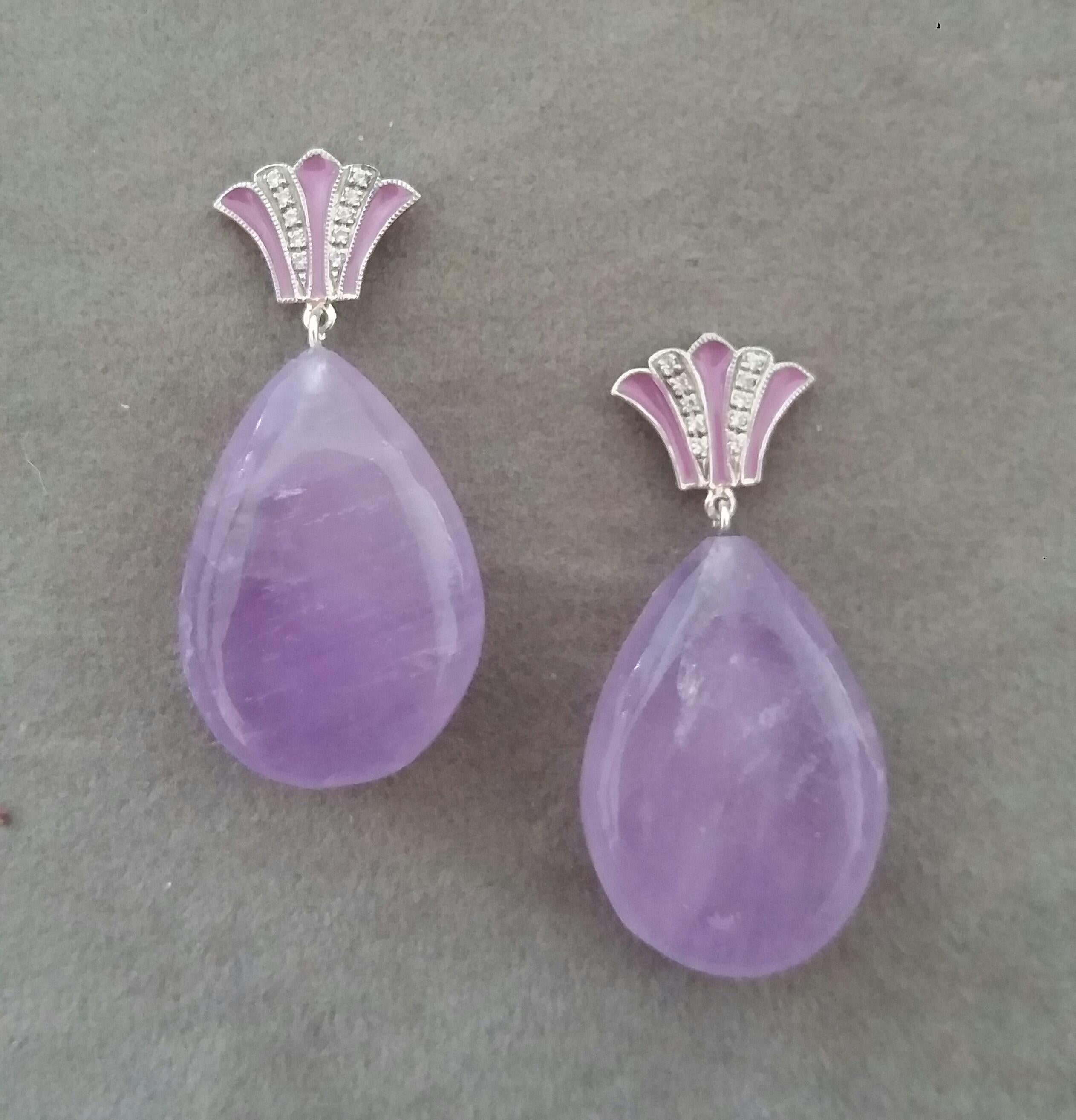 Unique pair of Amethyst Drops earrings with on top 2 white gold elements  in a Crown shape with 20 full cut round Diamonds and Lavender Enamel. In the bottom parts we have 2 Amethyst Plain Drops measuring 18x 26 mm.

In 1978 our workshop started in