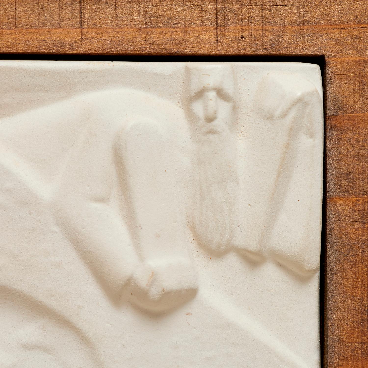 A plaster relief sculpture by Russian American artist George Aarons (1896-1980) depicts Moses with the Ten Commandments in a stylized, abstract form. The sculpture presents Moses with a long beard, symbolizing wisdom and authority, while he holds