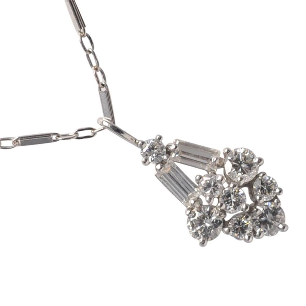 Pretty and chic, 1950s Art Deco style diamond pendant mounted in platinum.  It is composed of brilliant and baguette diamonds totalling 1.10ct; length 2cms x width 1cm.  Weight 4.2gms.  The pendant is on a fine 14ct 16