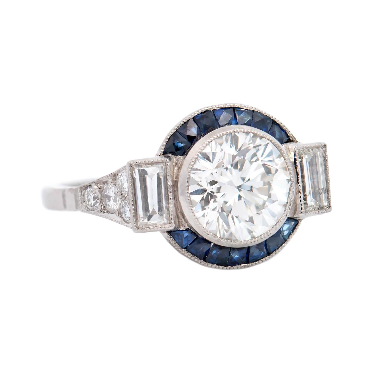 An outstanding contemporarily made engagement ring in the Art Deco style! This stunning piece is crafted in platinum and features a gorgeous old European Cut diamond resting in the center of an exquisite setting. The bezel set diamond weighs