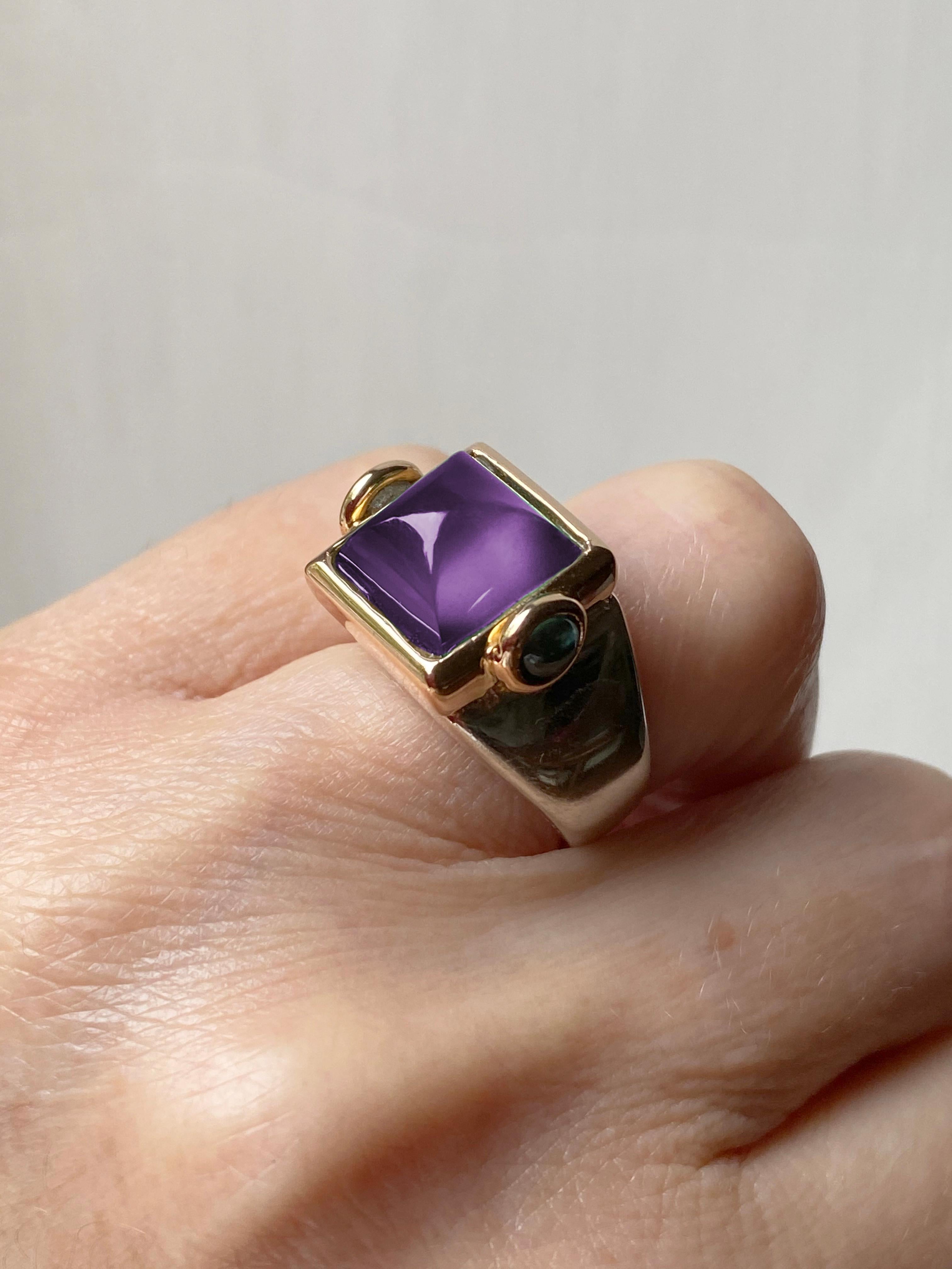 Introducing Rossella Ugolini's captivating design collection, meticulously handcrafted in Platinum and 18K Yellow Gold, featuring a striking Pyramid Cut Amethyst accented by two cabochon Green Tourmalines. This exceptional craftsmanship, originating