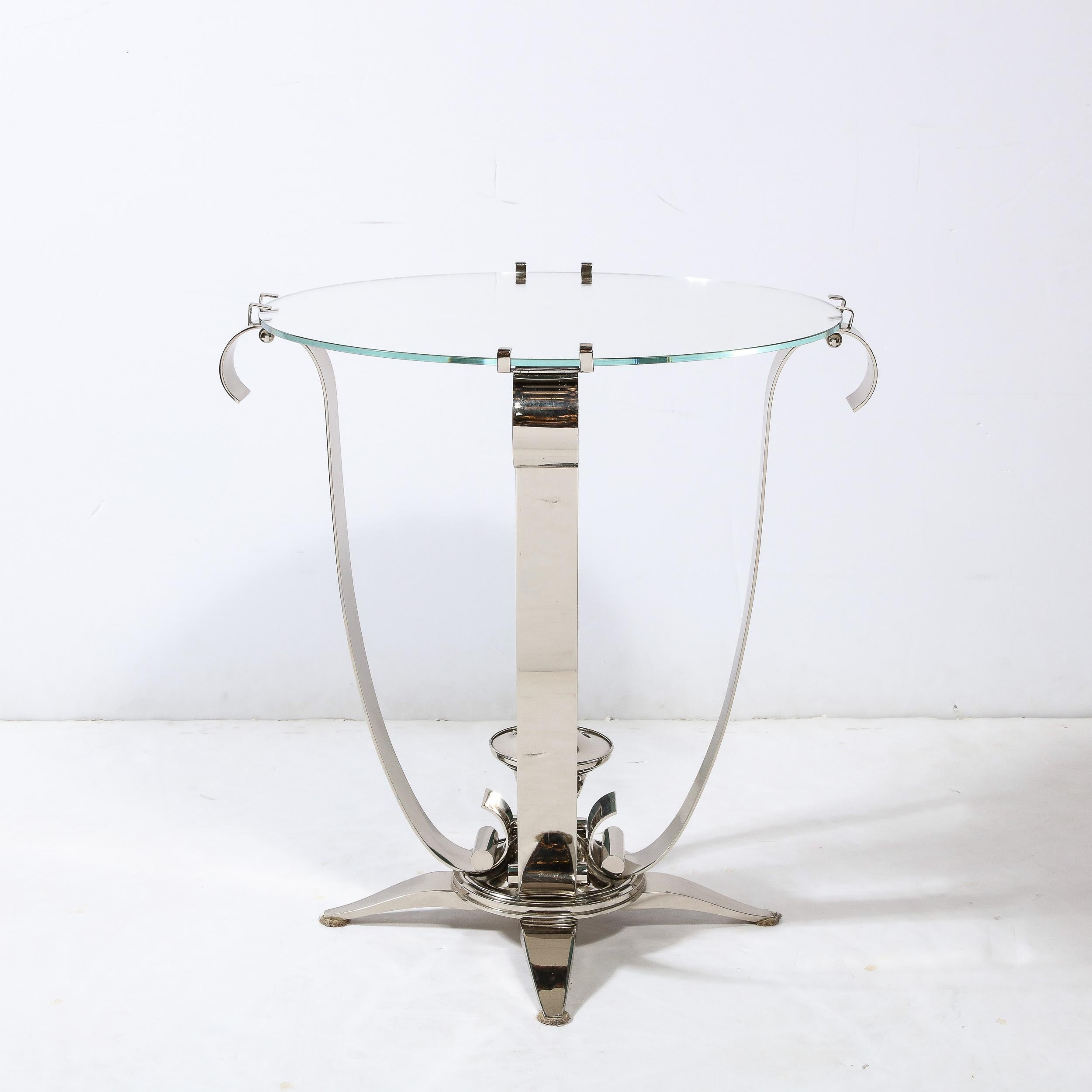 This elegant and well crafted Art Deco Style polished Nickel Side/End Table With Round Mirror Top originates from the United States during the latter half of the 20th Century. Featuring a gorgeous mirror top beautifully cut and integrated with the