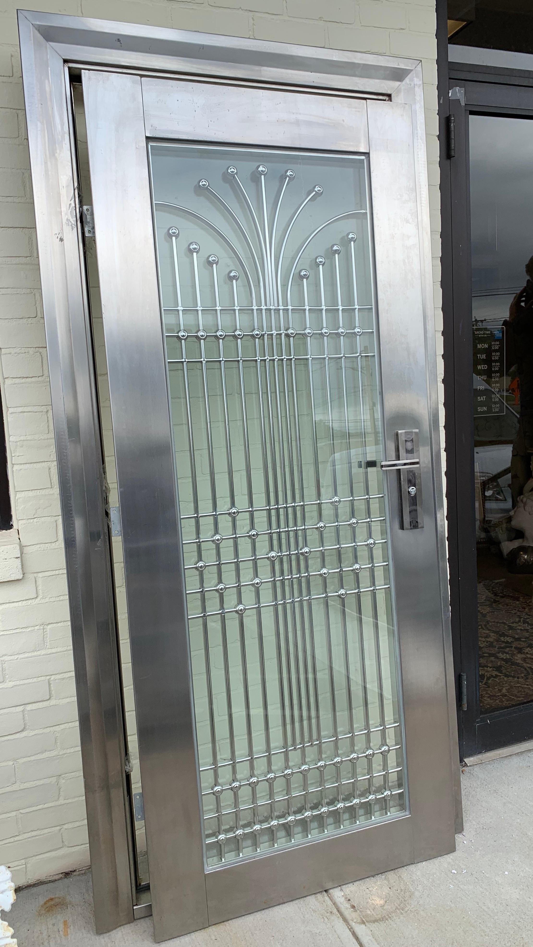 Magnificent, one of a kind, custom Art Deco style polished steel, chrome and laminated glass door complete with structure frame. The polished steel has been laser cut for perfect fit. Guaranteed to
set your home apart as no one else will have the