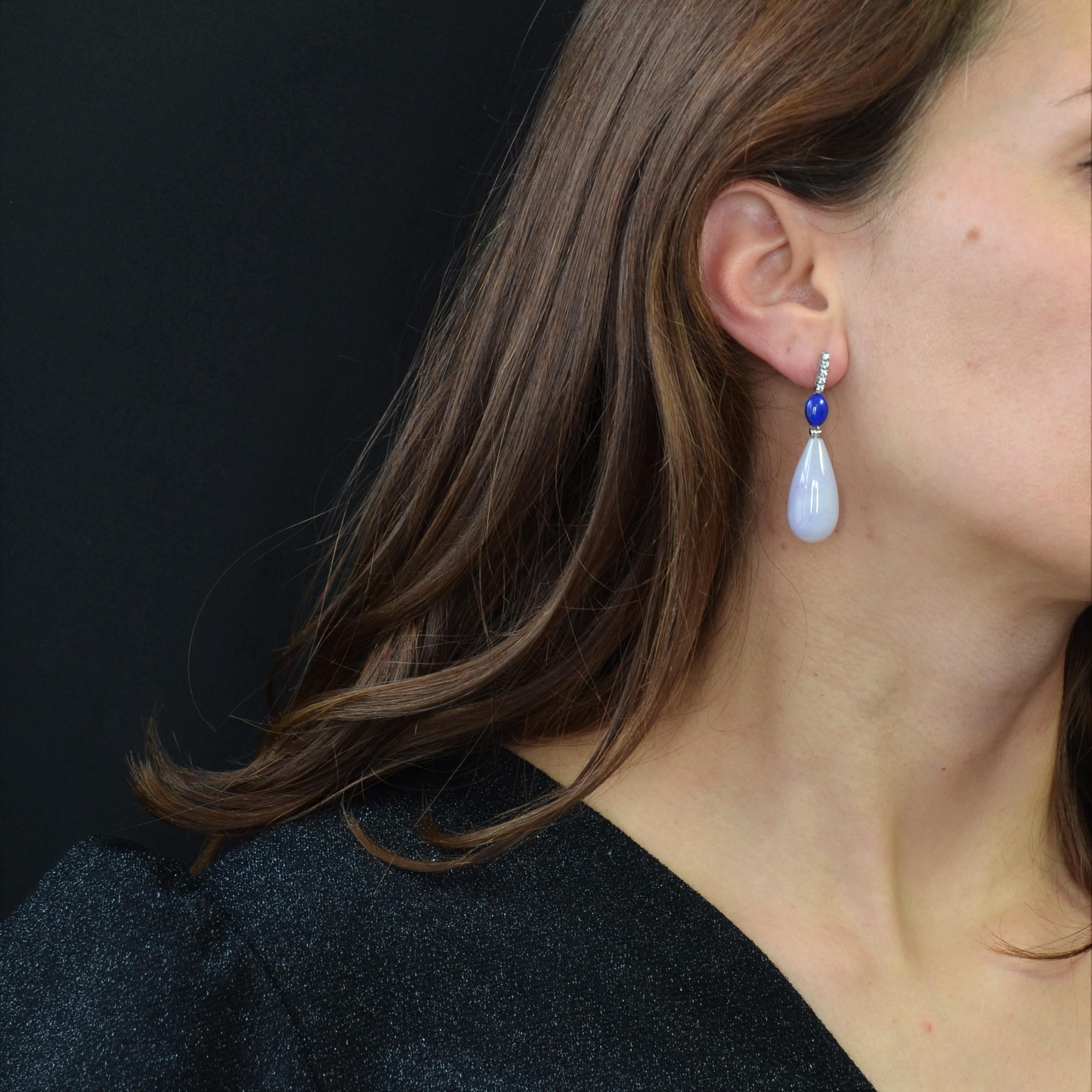 For pierced ears.
Earrings in 18 karat white gold.
Each art deco style earring is formed of a line of 5 modern brilliant- cut diamonds which holds an oval shape cabochon of lapis lazuli and an important drop of jade jadeite parma, the whole