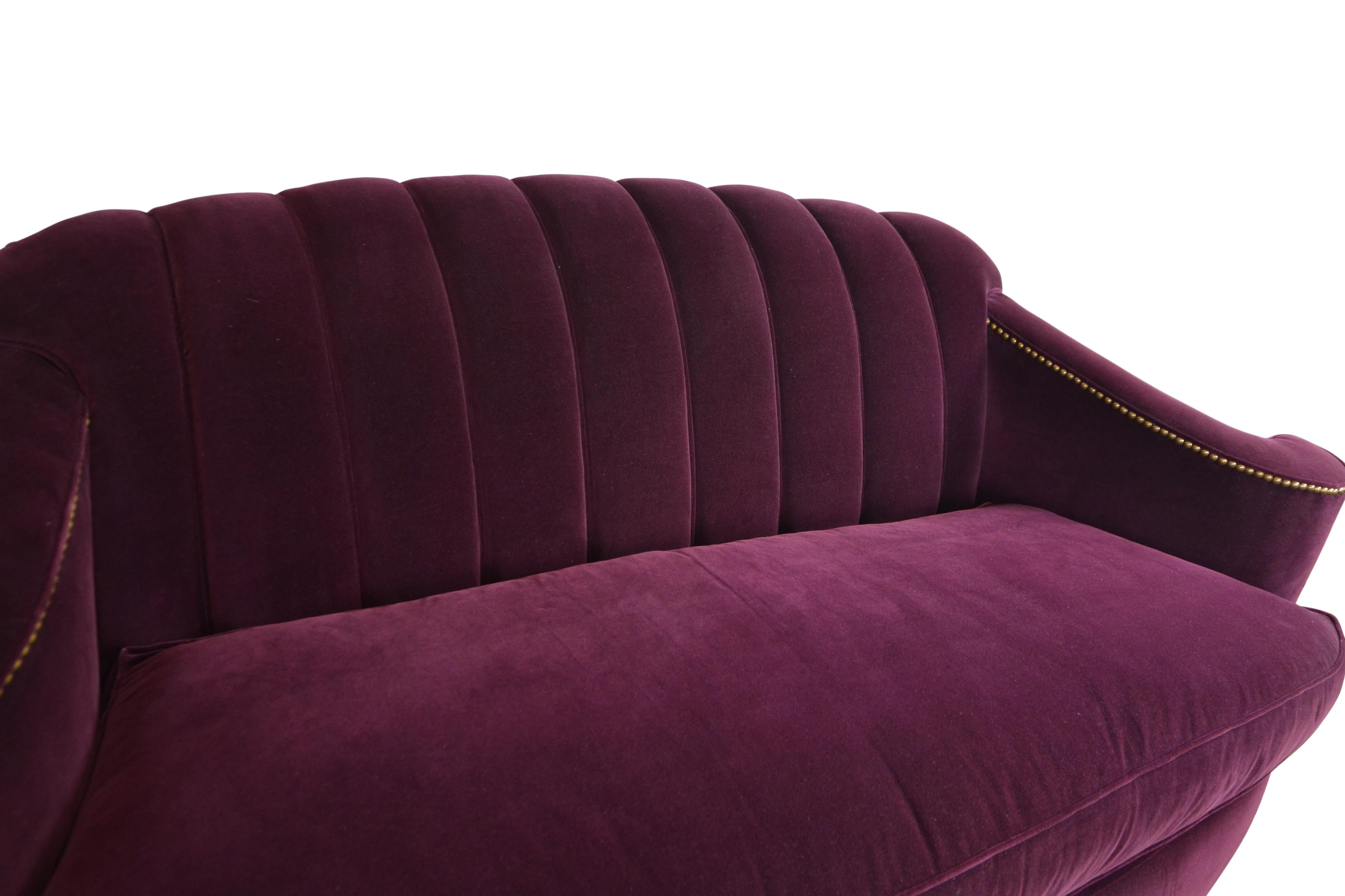 Art Deco style sofa covered in beautiful purple velvet fabric. Channel back beautifully curved arms and ball feet. Down cushion.