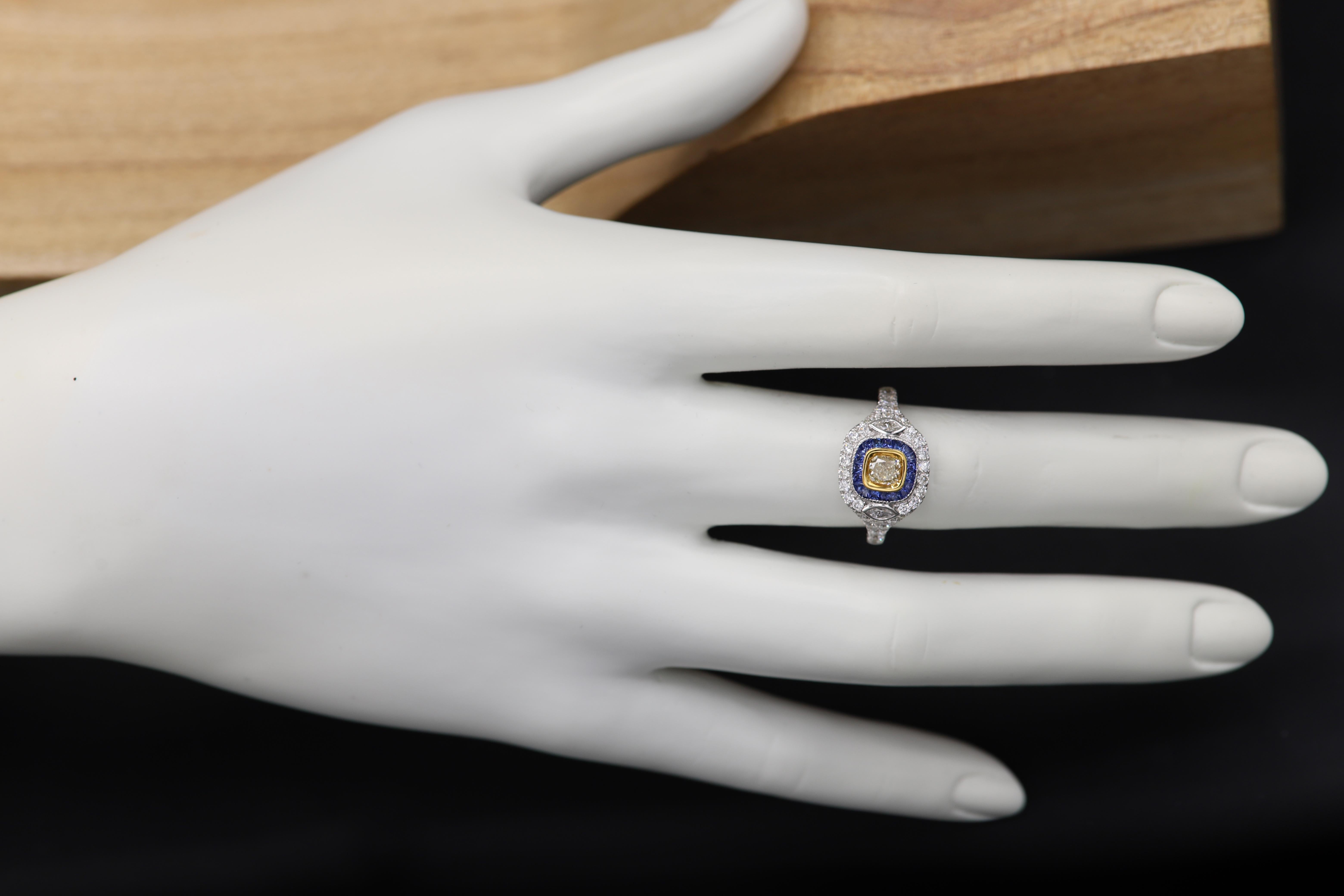 Brilliant Art Deco Style Ring. 18k White Gold 6.10 grams. Total all Diamonds 1.40 carat (center stone is cushion light Yellow diamond 0.49 carat)arround it - Blue sapphire total 0.45carat (baguettes) overall design area size on the top is 12 x 12