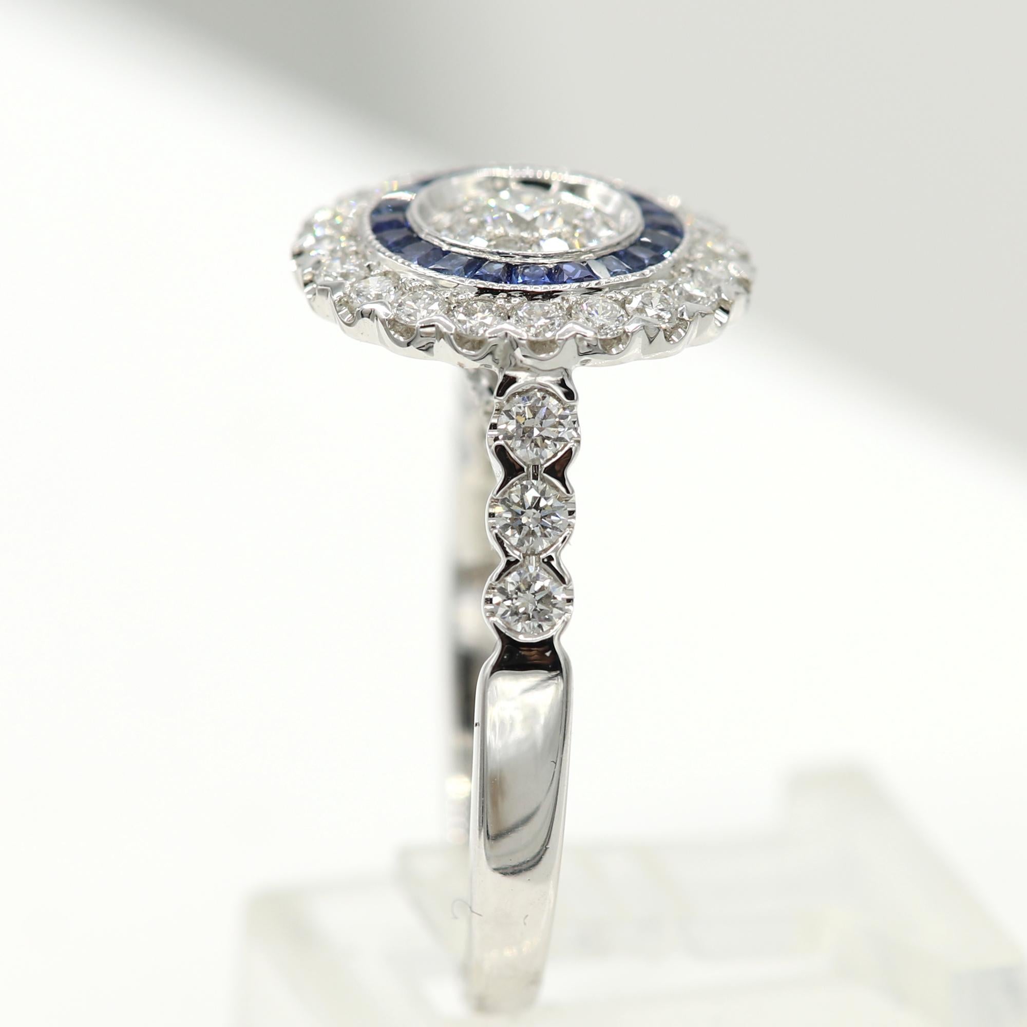 Brilliant Art Deco Style Ring. 18k White Gold 6.40 grams. Total all Diamonds 1.06 carat (center stones are a super cluster of diamonds that look as a single stone to the eye) GH-SI. Blue sapphire total 0.41 carat. design area on top diameter approx
