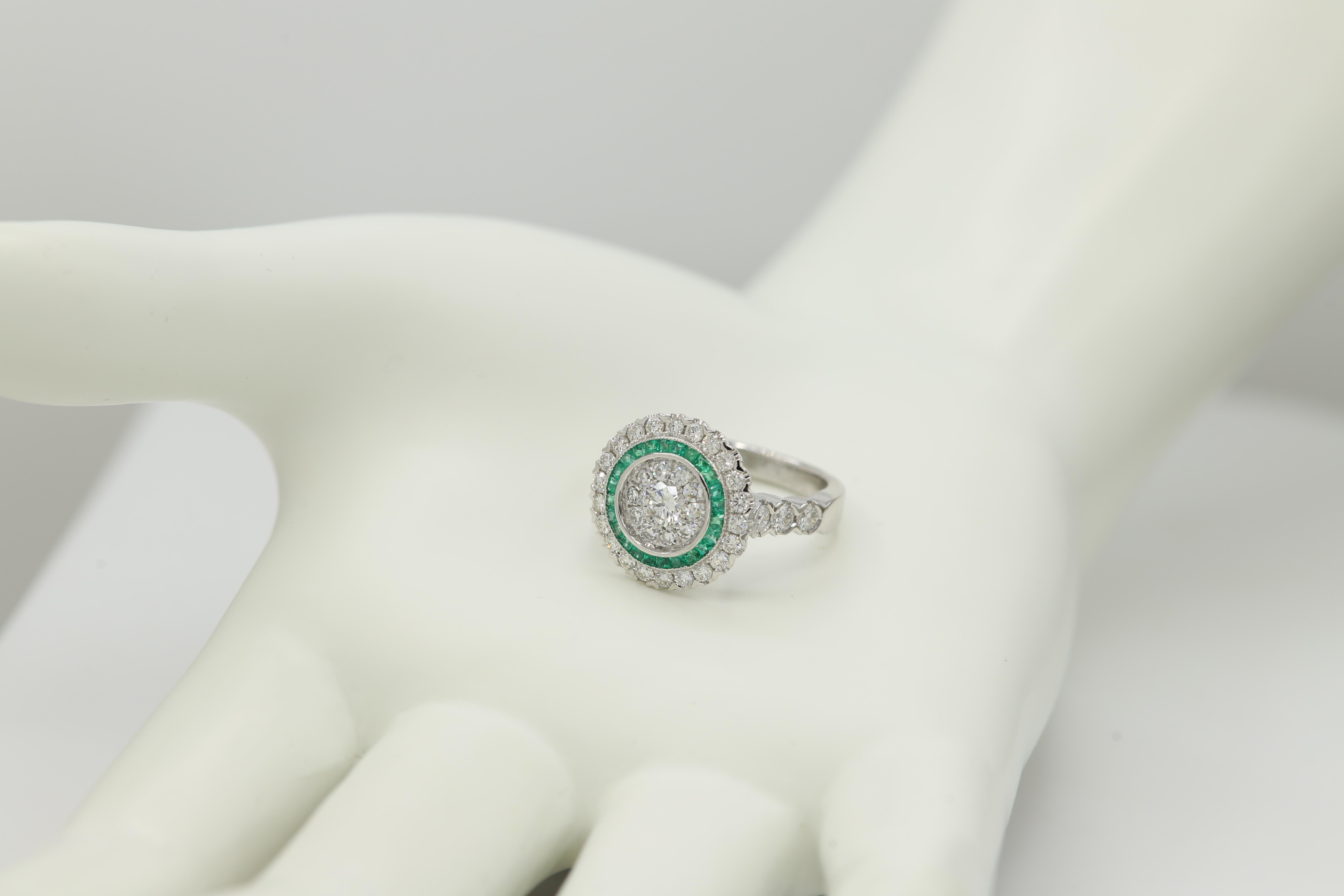 Brilliant Art Deco Style Ring. 18k White Gold 8.0 grams. Total all Diamonds 1.75 carat (center stones are a super cluster of diamonds that look as a single stone to the eye) GH-SI. Emerald total 0.45 carat. design area on top diameter approx 16 mm