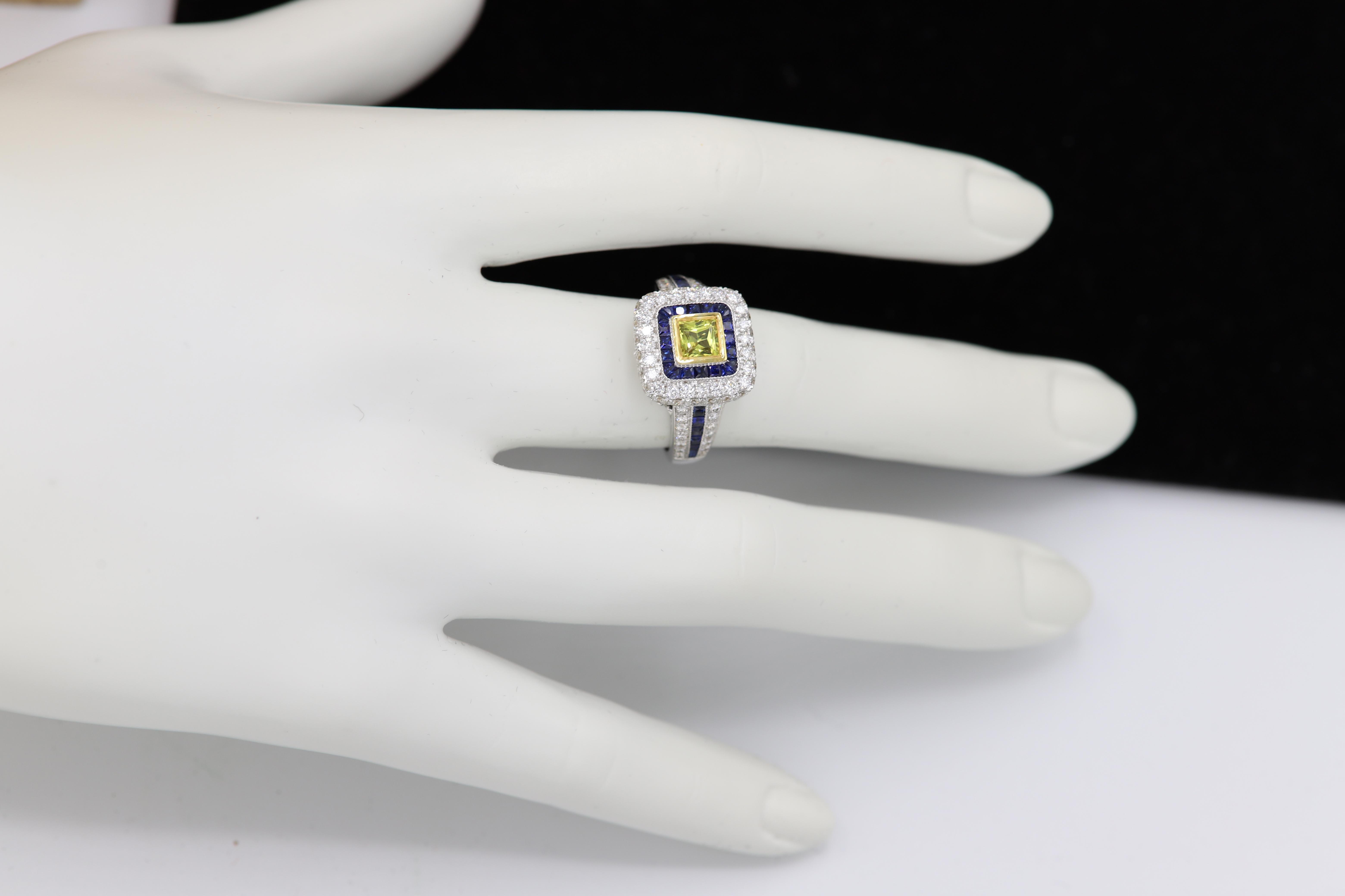 Brilliant Art Deco Style Ring. 18k White Gold 9.80 grams. Total all Diamonds 1.55 carat (center stone is princess cut Yellow Sapphire 0.70 carat) Blue sapphire total 0.97 carat. overall design area size on the top is 13 x 13 mm. Finger size