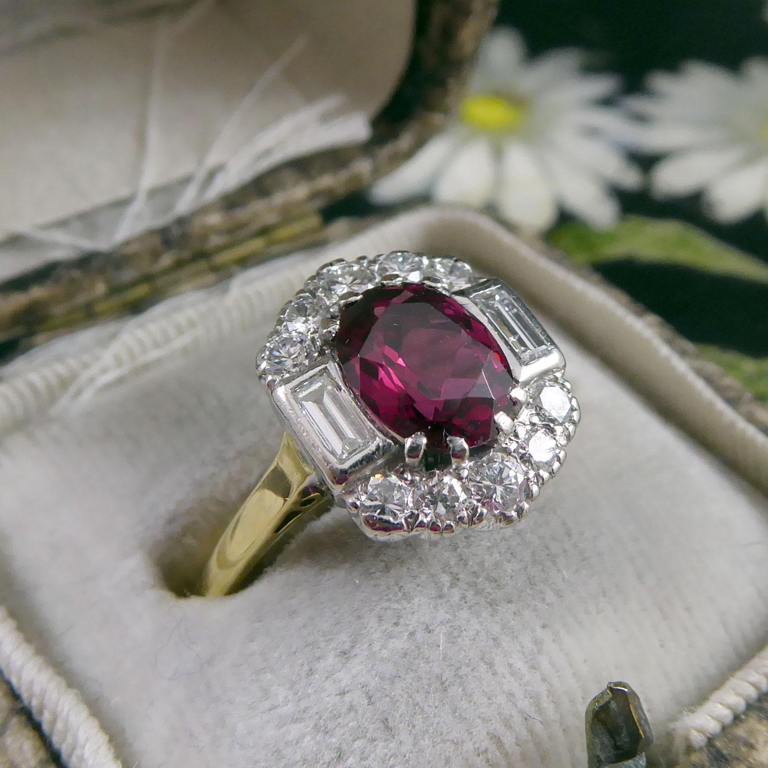 Here's a ring to keep everyone guessing.  It's set with a 1.26ct red spinel to the centre of a diamond cluster. 

The spinel is an oval-shaped mix cut held in four white claws with a rub-over set baguette cut diamond to each side and with an arch of