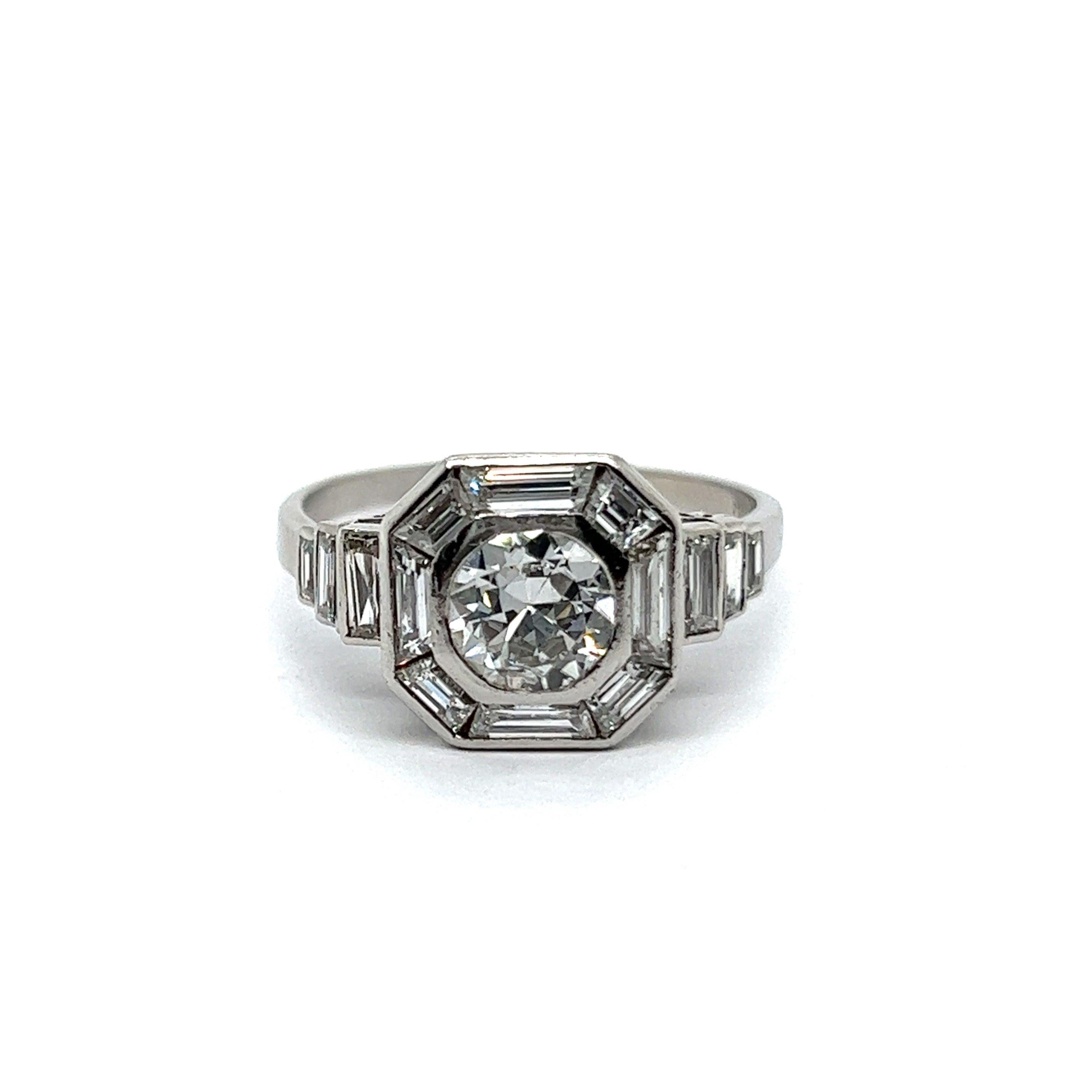 Introducing a captivating Art Deco-inspired ring with diamonds.  At the heart of this glamorous piece lies a resplendent 0.75-carat brilliant-cut diamond, surrounded by an entourage of 14 dazzling diamonds. The central diamond, in a brilliant H-I