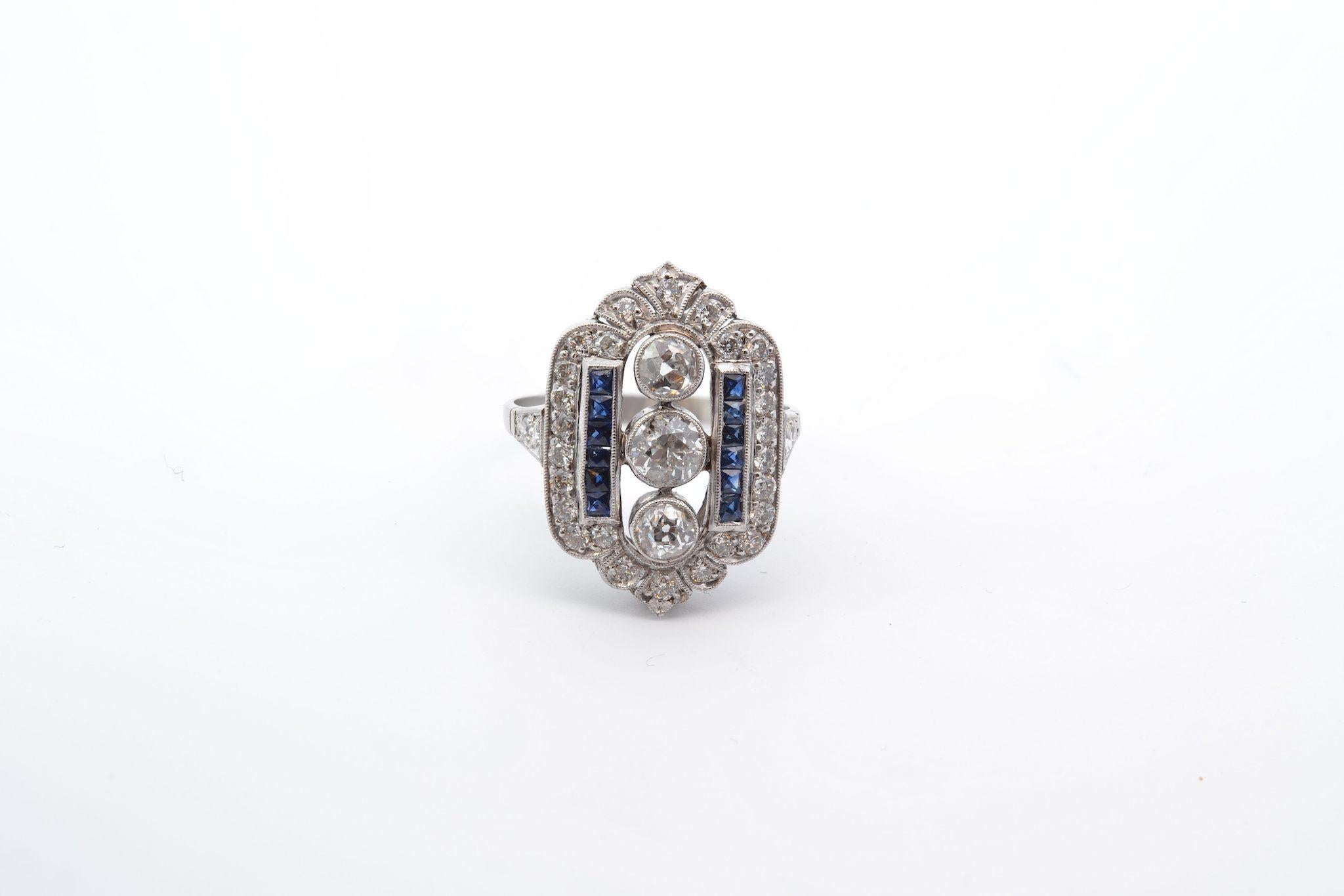 Stones: 33 diamonds: 1.75cts, 12 calibrated sapphires: 0.60ct
Material: Platinum
Dimensions: 2.3cm x 1.5cm
Weight: 6g
Period: Art Deco style
Size: 57 (free sizing)
Certificate
Ref. : 25175