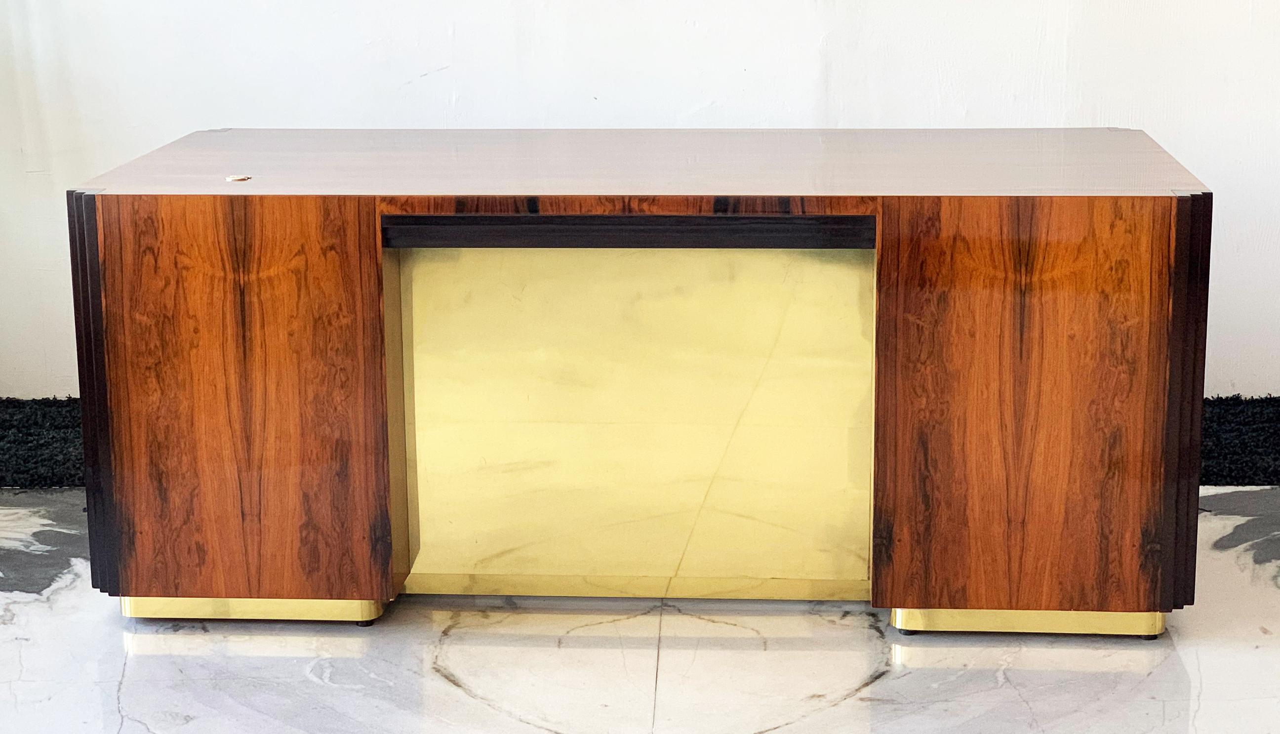 The craftsmanship on this desk is so good it would make even Milo Baughman blush. This desk is STUNNING-- from every angle. Clad in the most gorgeous grained rosewood and brass, this executive desk is sure to make a statement. 

We had this late