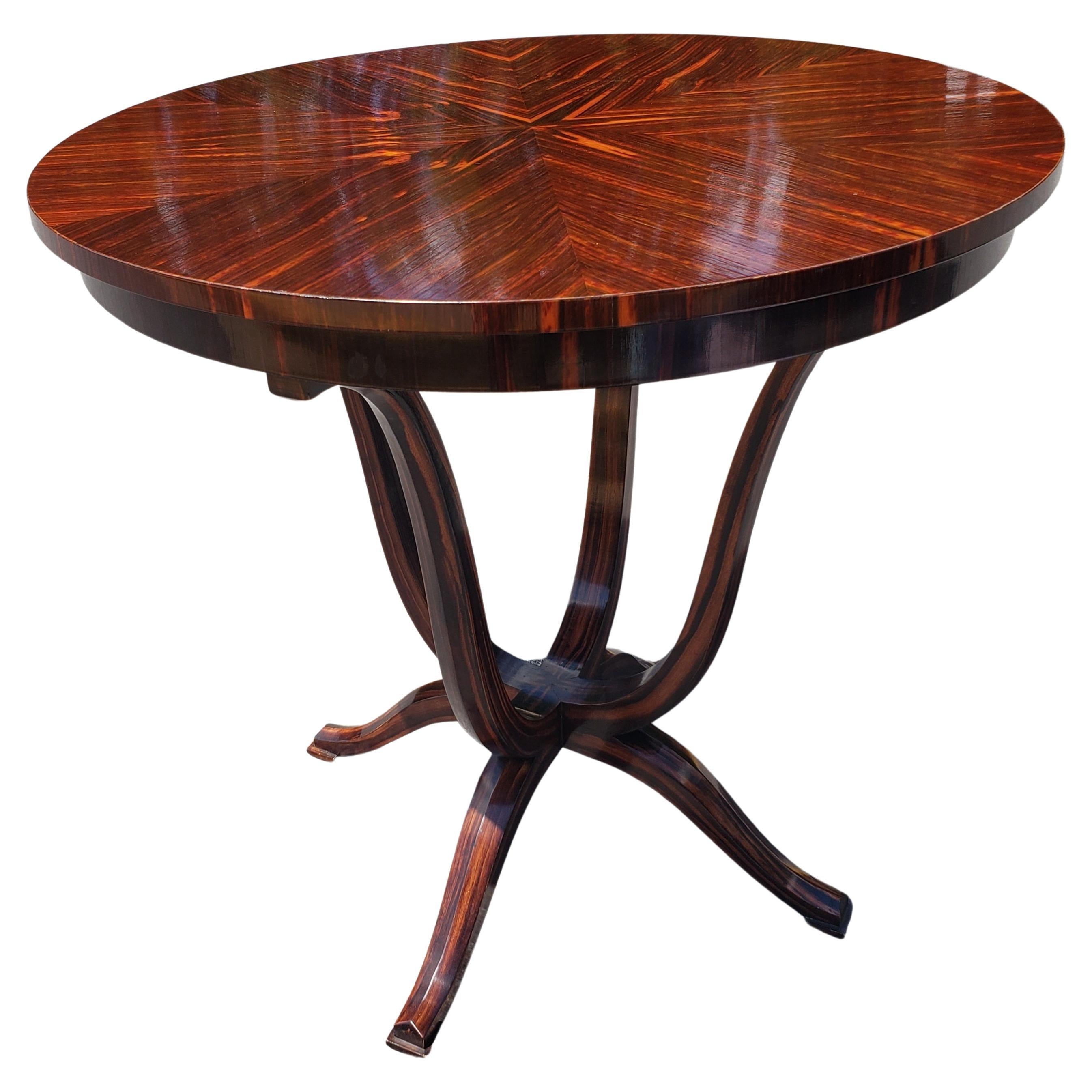A beautiful late 20th century Art Deco style rosewood center table. Quad Legs and quad feet.
Very good vintage condition with marginal signs of use. Measures 31 inches in diameter and stands 30 inches tall.