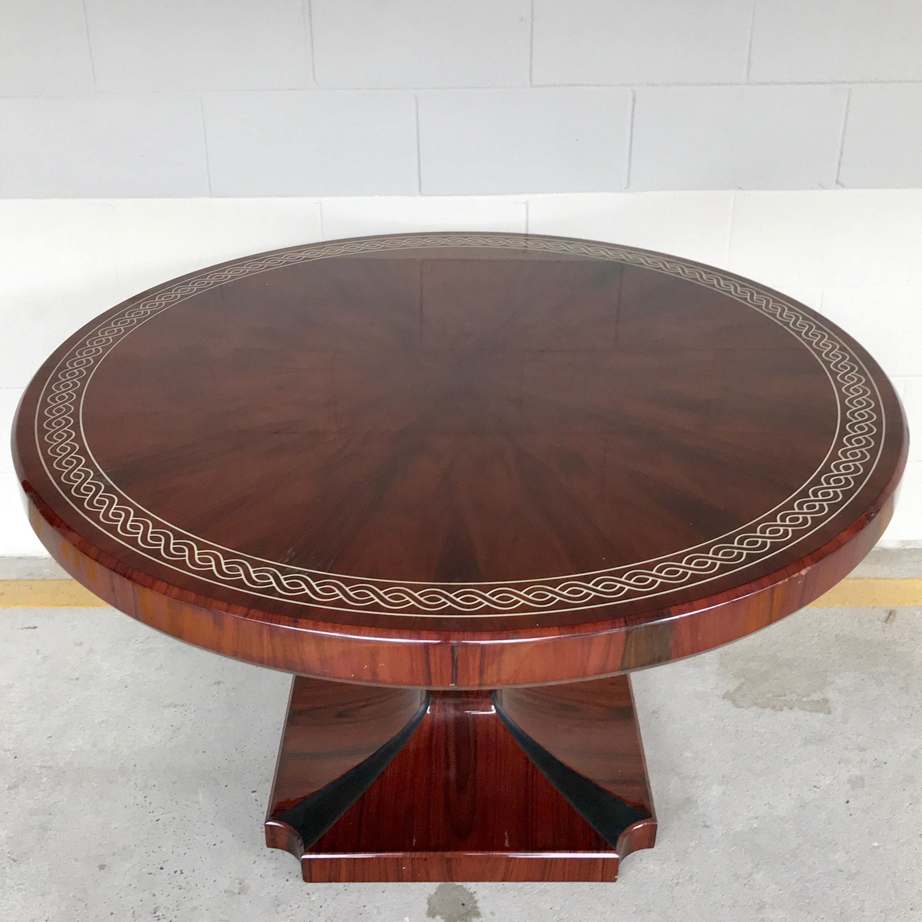 Art Deco style rosewood centre table with lacquer inlay, the circular top raised on a tapered urn pedestal base with inlaid ebony. Constructed in two pieces, the top is removable for shipping.