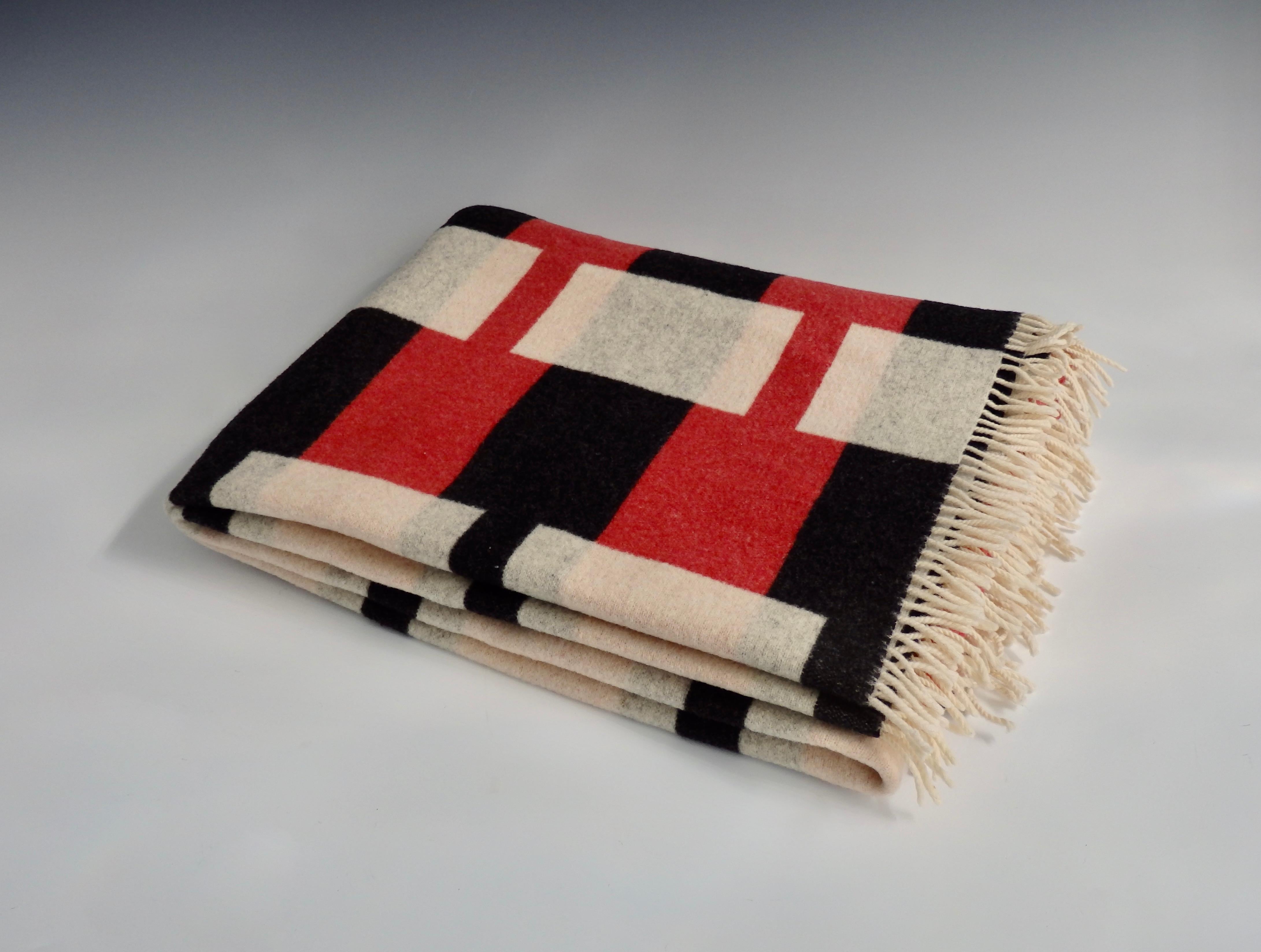 Art Deco style wool throw blanket.
Charcoal black, crimson red, and cream.
Made in New Zealand by Roslyn.