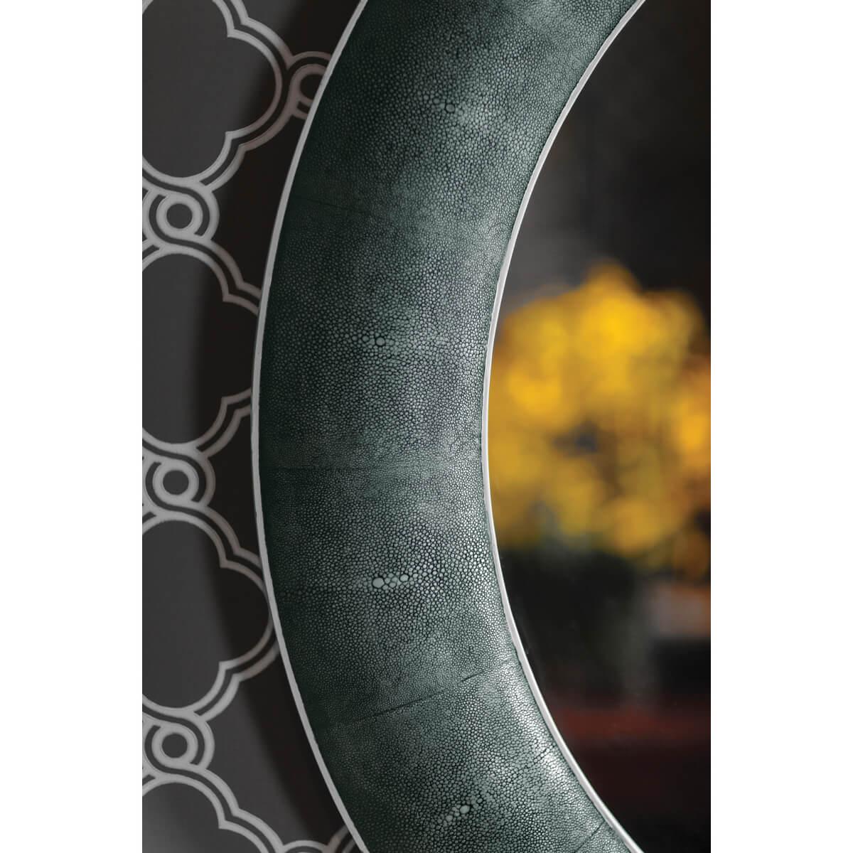 Large Art Deco style circular mirror with concave moulding veneered with faux shagreen and with a black rub-through faded finish. Plain mirrored glass.

Dimensions: 45.5