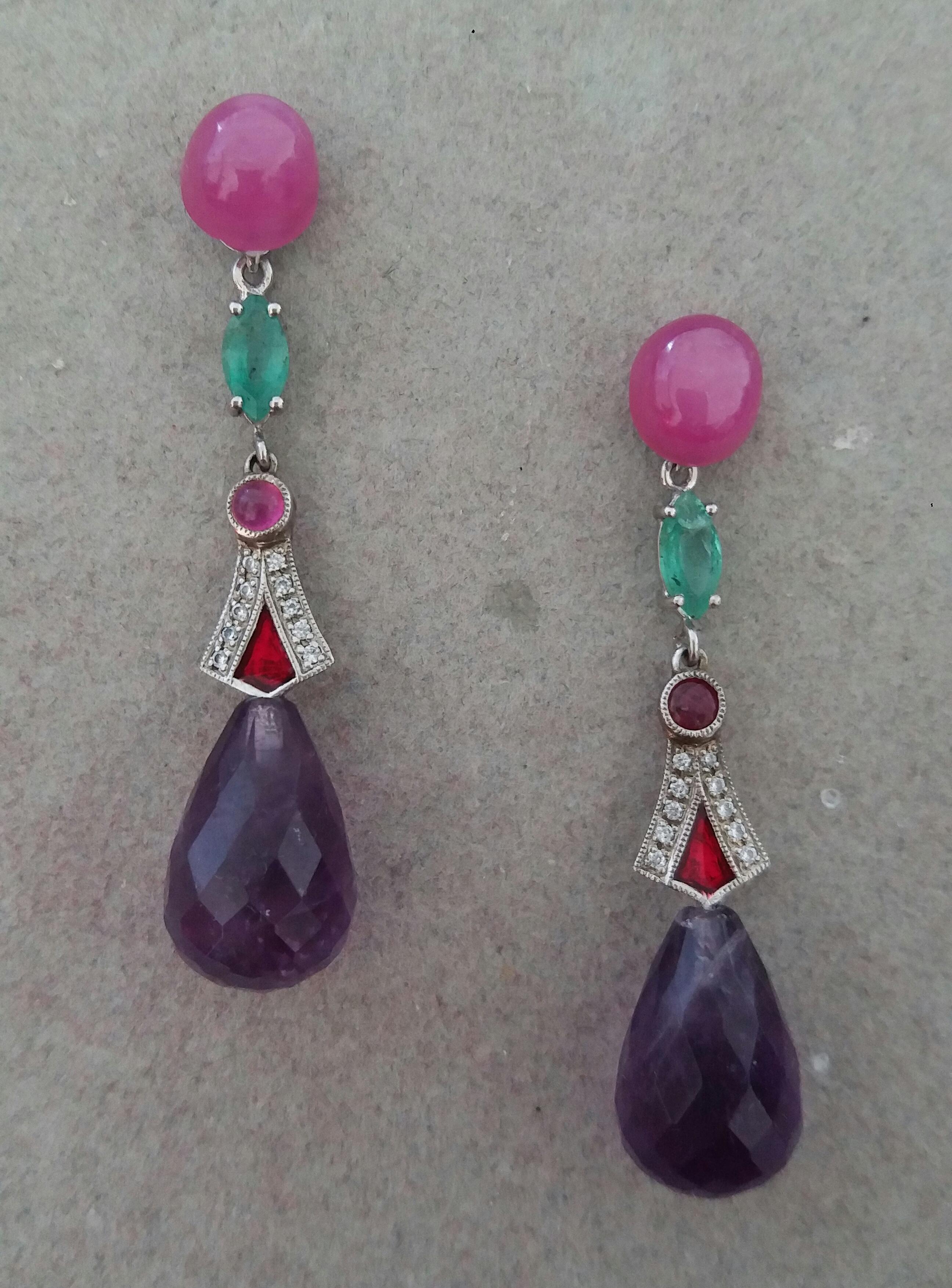 In these Art Deco Style earrings in the upper part we have 2  oval Ruby cabochons measuring 7 mm x 8 mm, the central part is composed of 2 elements in white gold ,20 full cut diamonds ,rubies ,emeralds and red enamel, the lower part we have 2