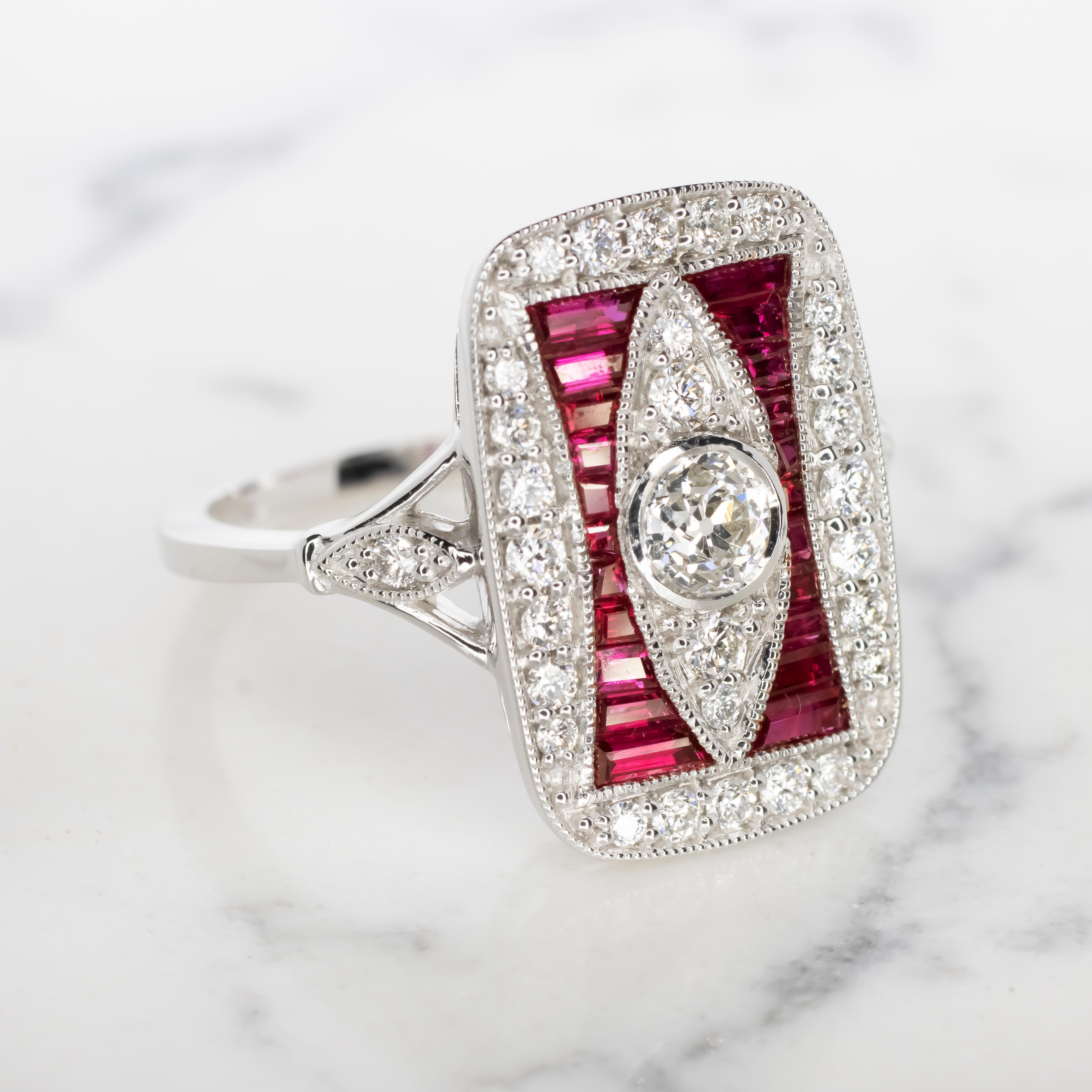 The chic setting is set with brilliantly white and vibrant natural diamonds as well as rich red custom cut natural rubies. Finished with dazzling diamonds and fine milgrain details, this bezel setting provides the perfect backdrop for a diamond or