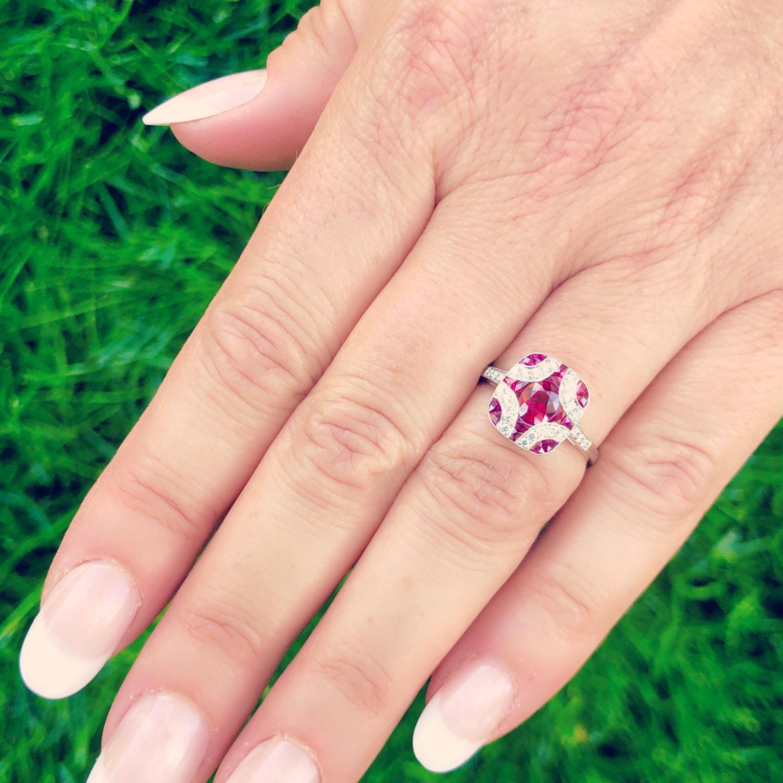 Art deco design and beautifully crafted, this platinum ring is reminiscent of an earlier era. Set with oval and calibre-cut rubies totaling 1.20 carats, and highlighted with sparkling round brilliant-cut diamonds, the ring is eye-catching and