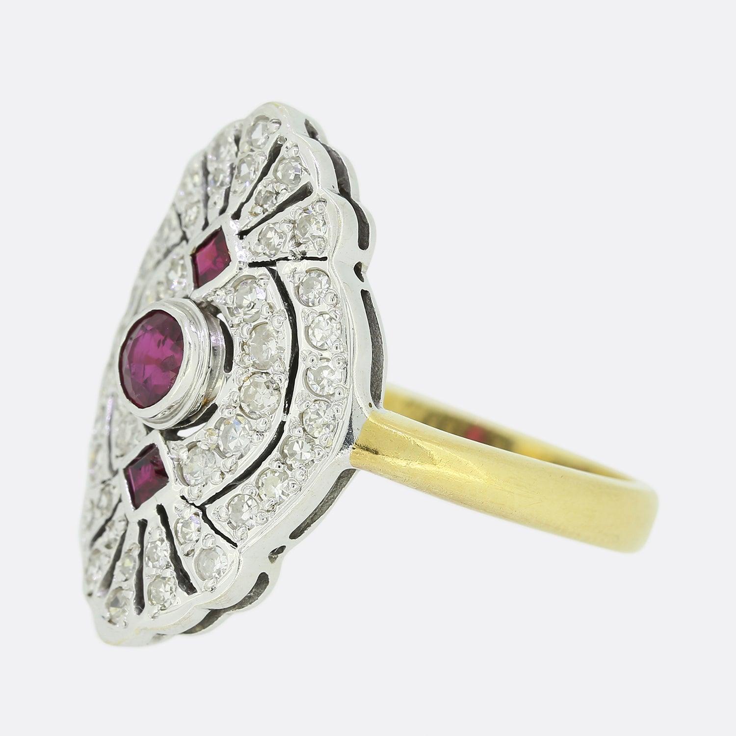 This is an 18ct yellow gold Art Deco style ruby and diamond tablet ring. The focal point of the ring is the single, slightly risen rub-over set ruby at the centre of the piece and the two square shaped rubies; one atop and one below. The ornate,