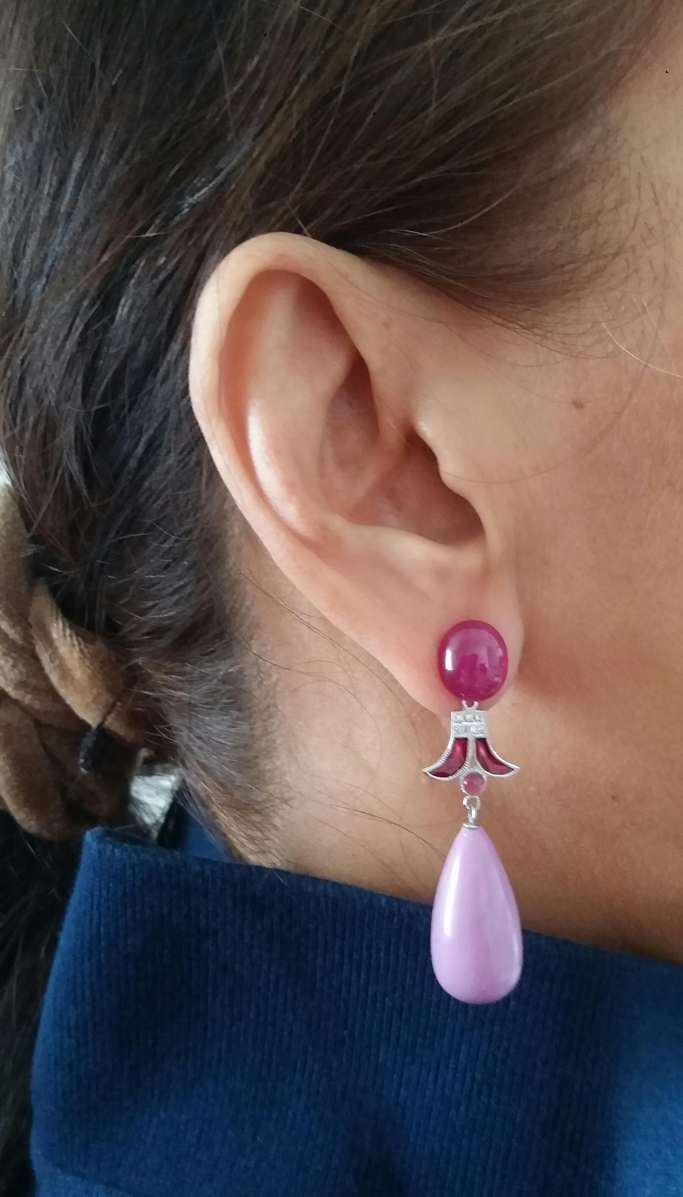 Un paio di orecchini in stile art déco, la parte superiore con 2 cabochon ovali di rubino che sostengono 2 elementi in oro bianco, diamanti e smalto rosso, mentre la parte inferiore è composta da 2 gocce rotonde di fosfosiderite che misurano 24 x 12