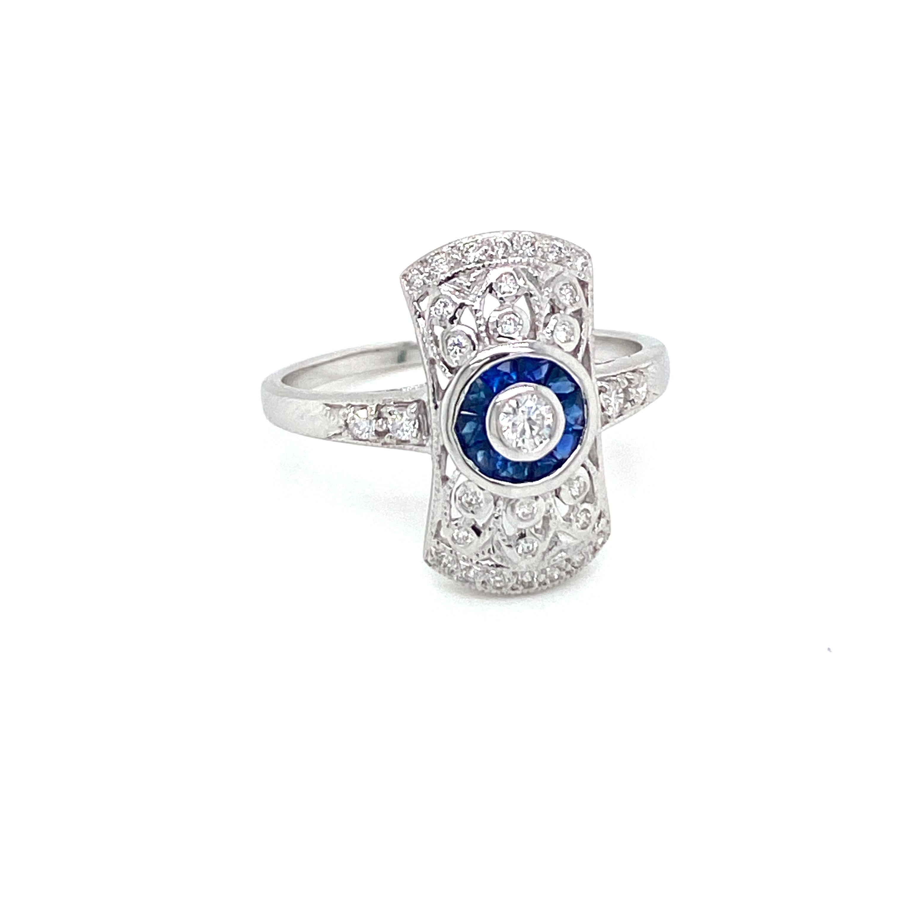 Beautiful Gold handmade Art Deco style ring.
It is set in 14k white Gold featuring a sparkling Round brilliant cut diamond in the center, surrounded by an halo of custom cut natural Sapphire, all embellished by Round brilliant cut diamonds G/H color