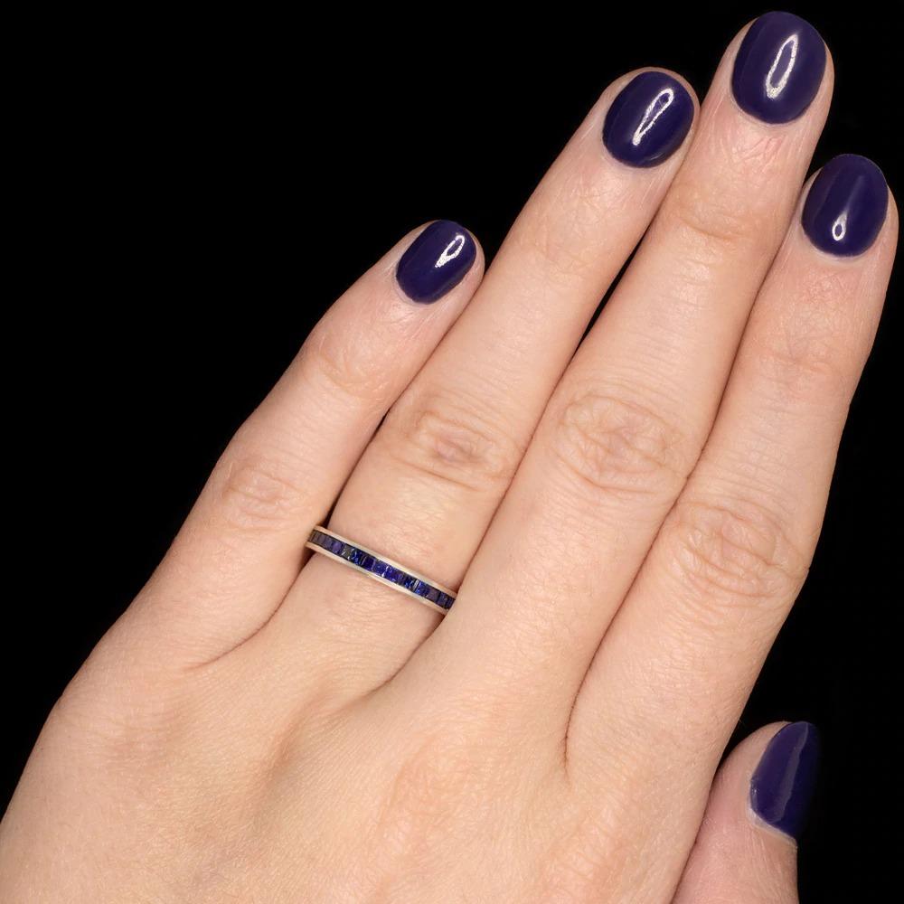  elegant vintage inspired eternity band beautifully designed to capture the chic style of the Art Deco era! The setting features rich blue natural french cut sapphires meticulously channel set to fit this channel set eternity band. Finished with