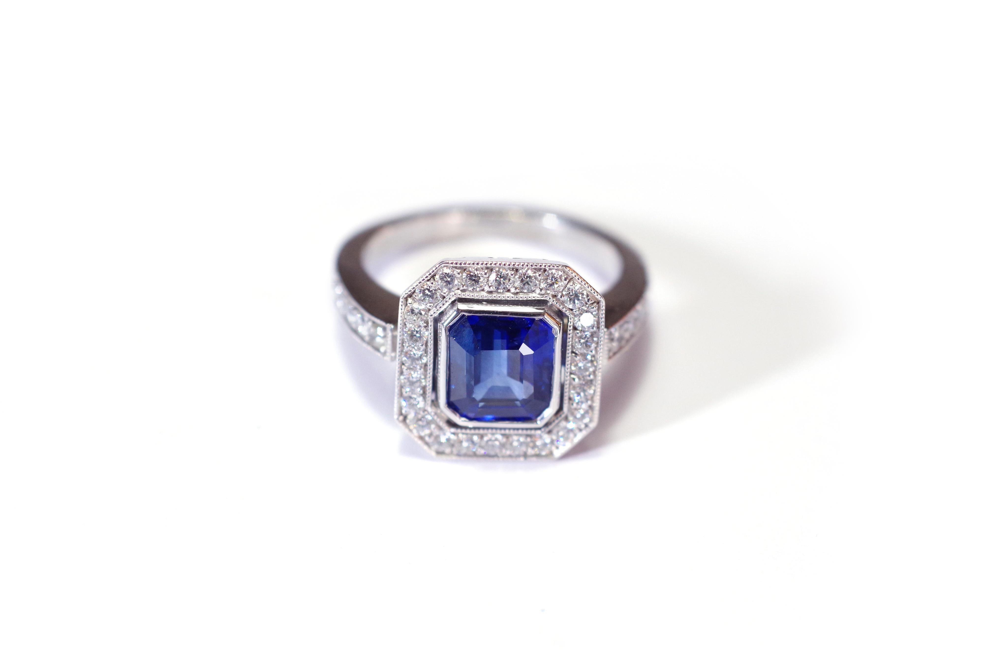 Art Deco style sapphire ring in white gold 18 karats. Important ring with an Art Deco style, within its center an intense blue sapphire of octagonal form. This is a natural sapphire from Madagascar. This sapphire is in close setting and surrounded