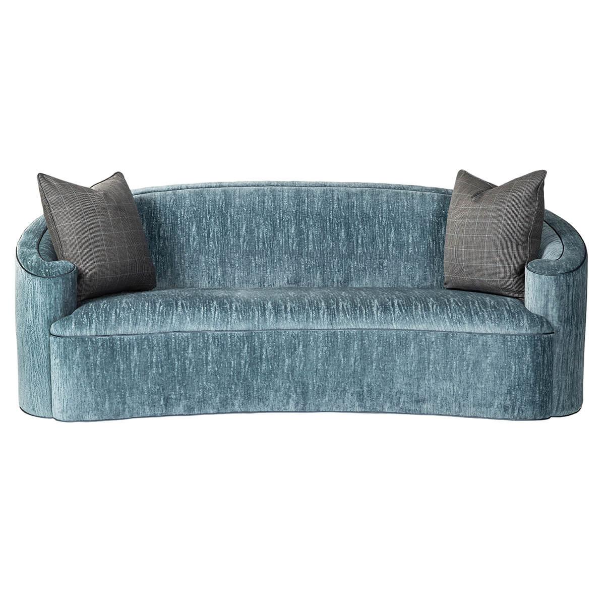 An Art Deco-inspired C-scroll form back upholstered sofa with curbed back and scroll form arms, a tight concave fronted seat with two throw pillows, and an over upholstered base.
Dimensions: 82