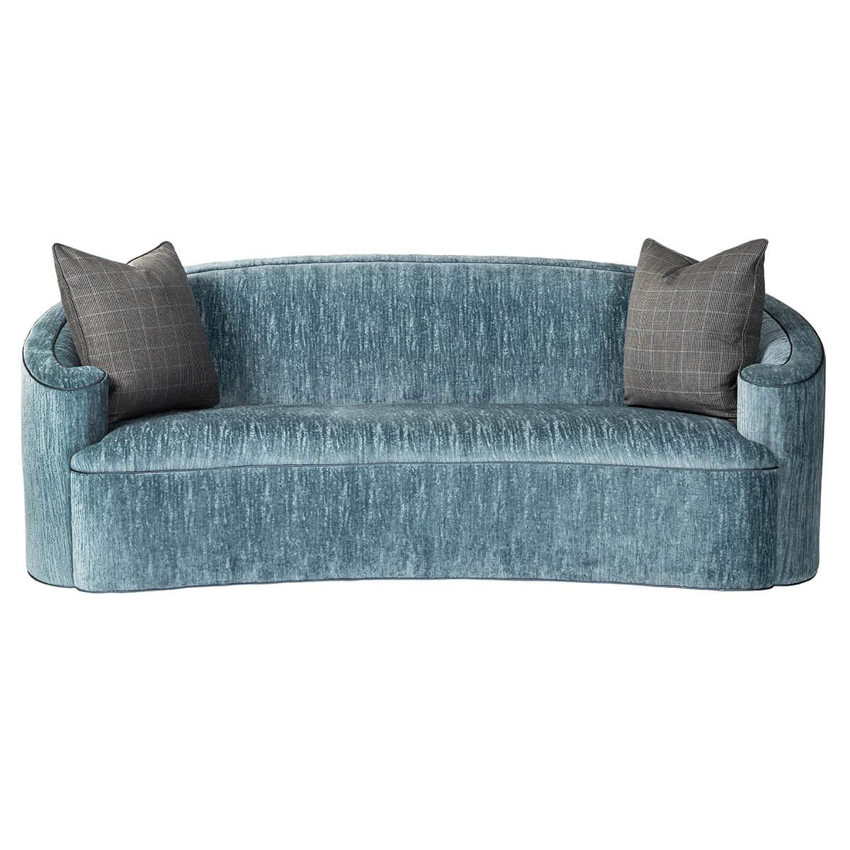 An Art Deco-inspired C-scroll form back upholstered sofa with curbed back and scroll form arms, a tight concave fronted seat with two throw pillows, and an over an upholstered base.
Dimensions: 82