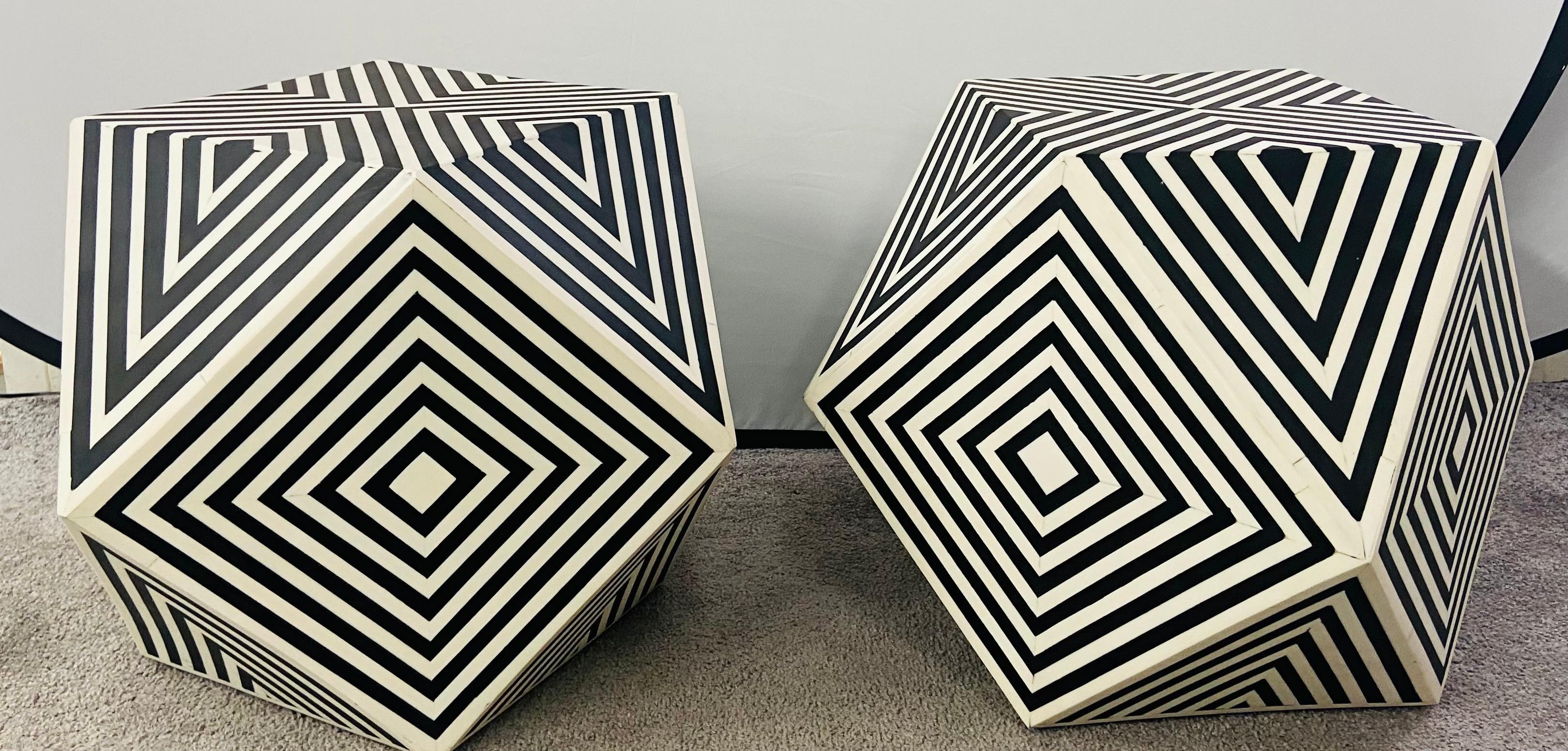 The one of a kind pair of Art Deco style sculptural side, end tables or stools features a geometrical bulky design .The sculptural solidly made table or stool is hand crafted of resin in a black and white stripes' pattern. Very stylish, the pair of