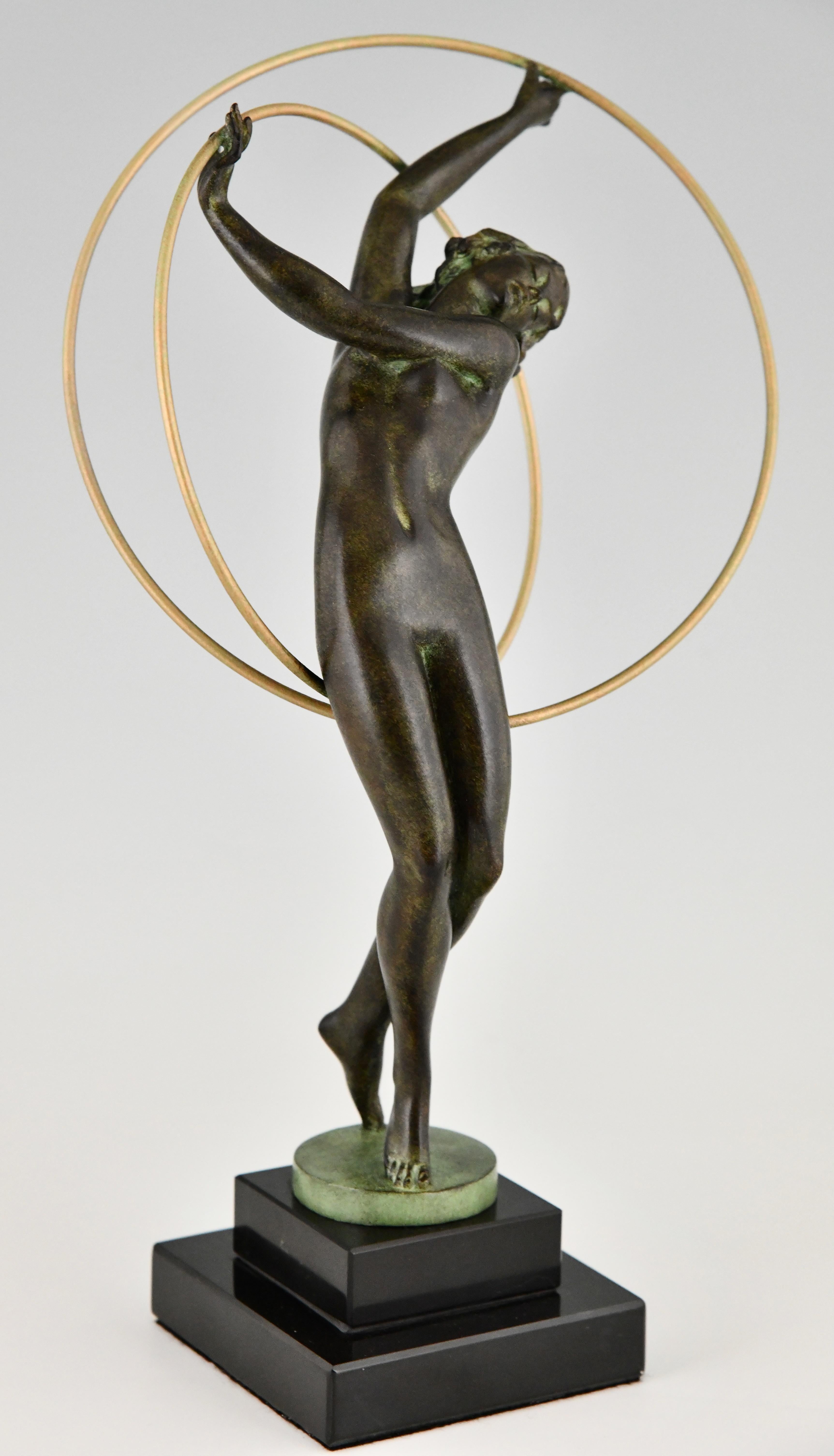 Art Deco style sculpture dancer Illusion signed by Fayral, pseudonym of Pierre Le Faguays.
Patinated Art Metal on a Black marble base. 
With the Le Verrier foundry mark. 
Design 1930.
Posthumous contemporary cast of the Le Verrier foundry. 
With