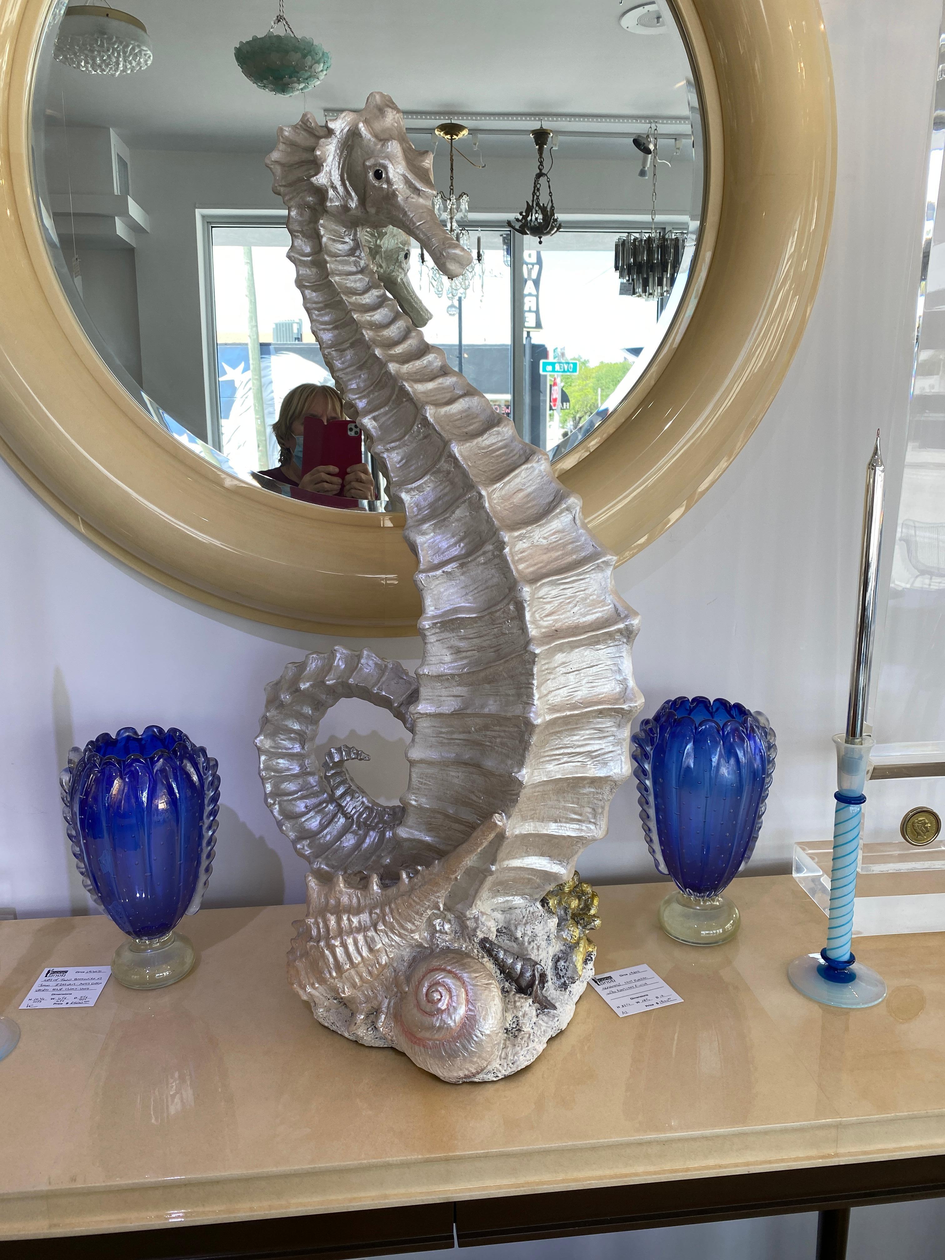 This large scale, chic and stylish piece takes its cue from the Art Deco, Hollywood Regency periods. The piece is cast in plaster and hand painted. The seahorse itself is finished in a pearlized coloration that catches the light beautifully.

